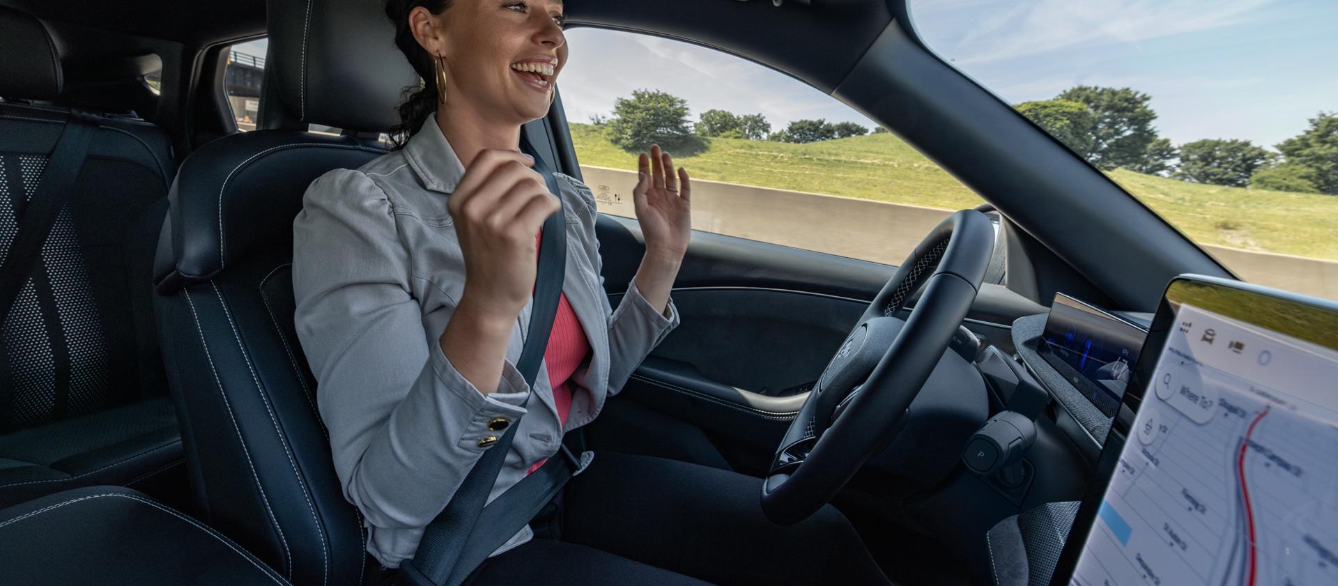 Woman using Ford BlueCruise hands-free highway driving in a 2025 Ford Mustang Mach-E®
