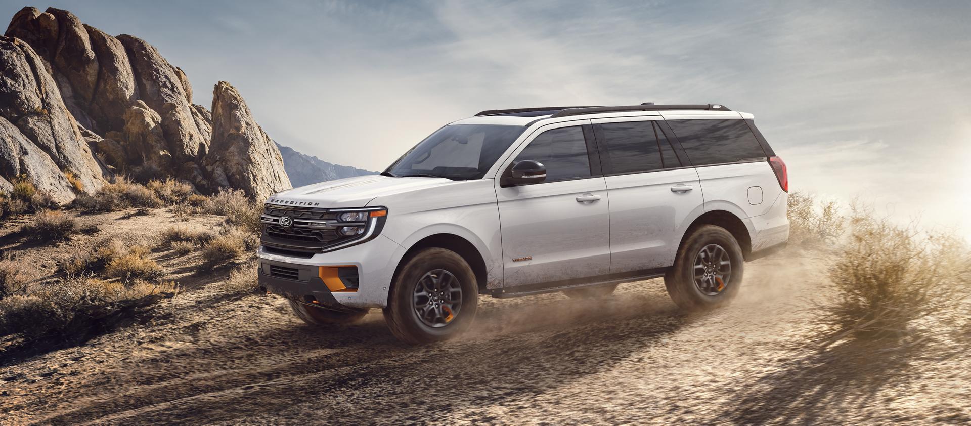 2026 Ford Expedition® Platinum™ model with a driver towing a boat on a trailer