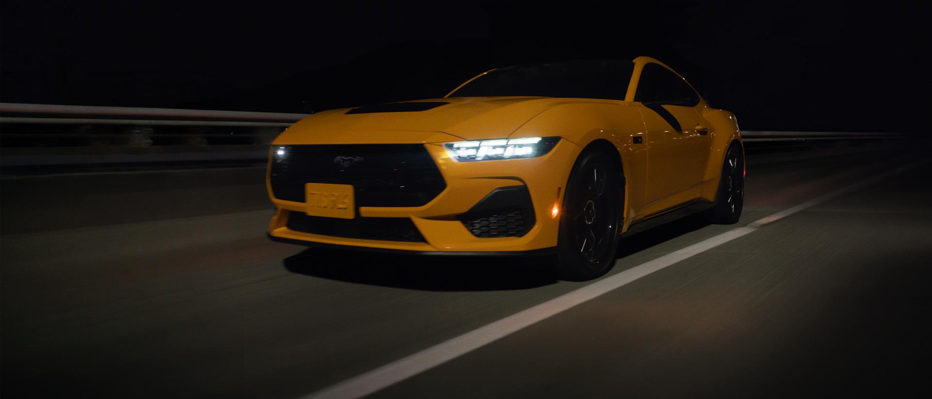 Mustang driving on a highway at night.