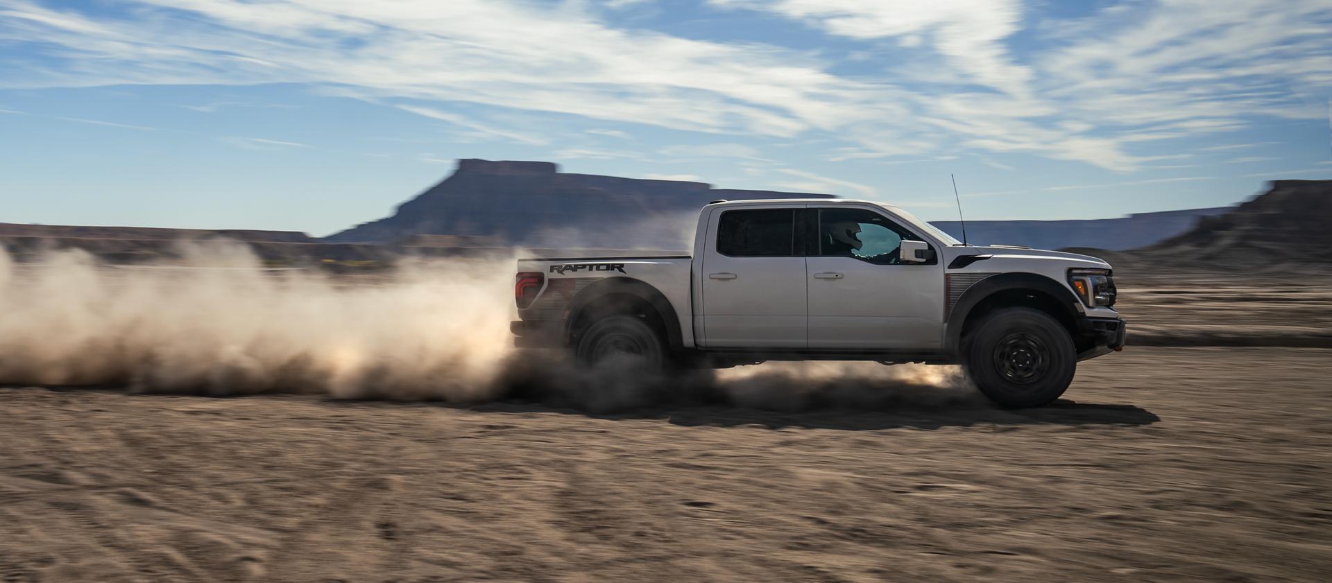 2025 Ford F-150® Raptor® R™ racing across the desert leaving a trail of dust behind