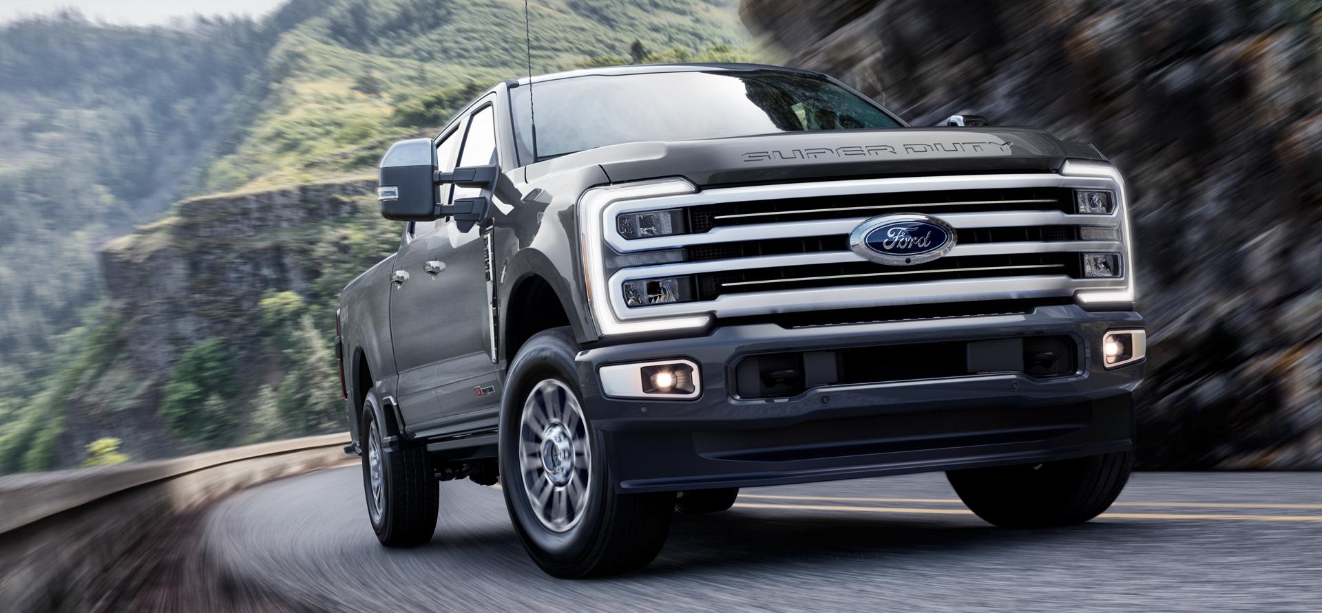 2026 Ford Super Duty® F-350® with the Platinum® Plus Package driving on a paved road in the mountains