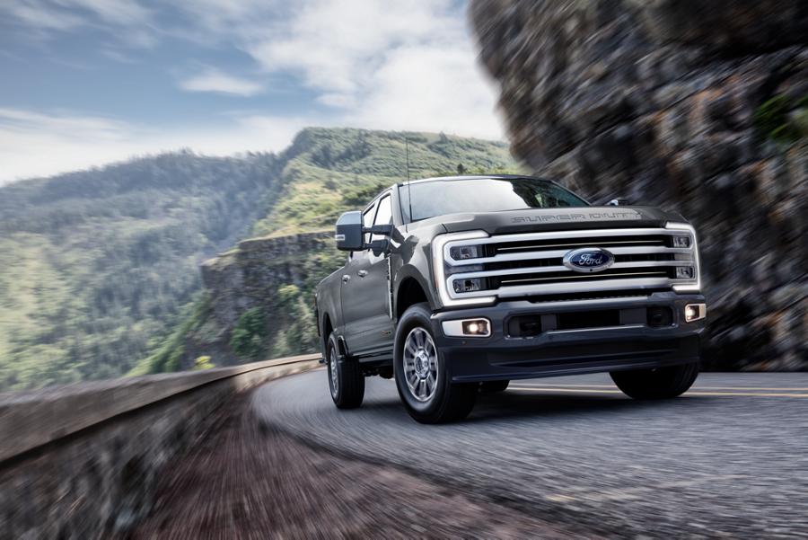 2026 Ford Super Duty® F-350® with the Platinum® Plus Package driving on a paved road in the mountains