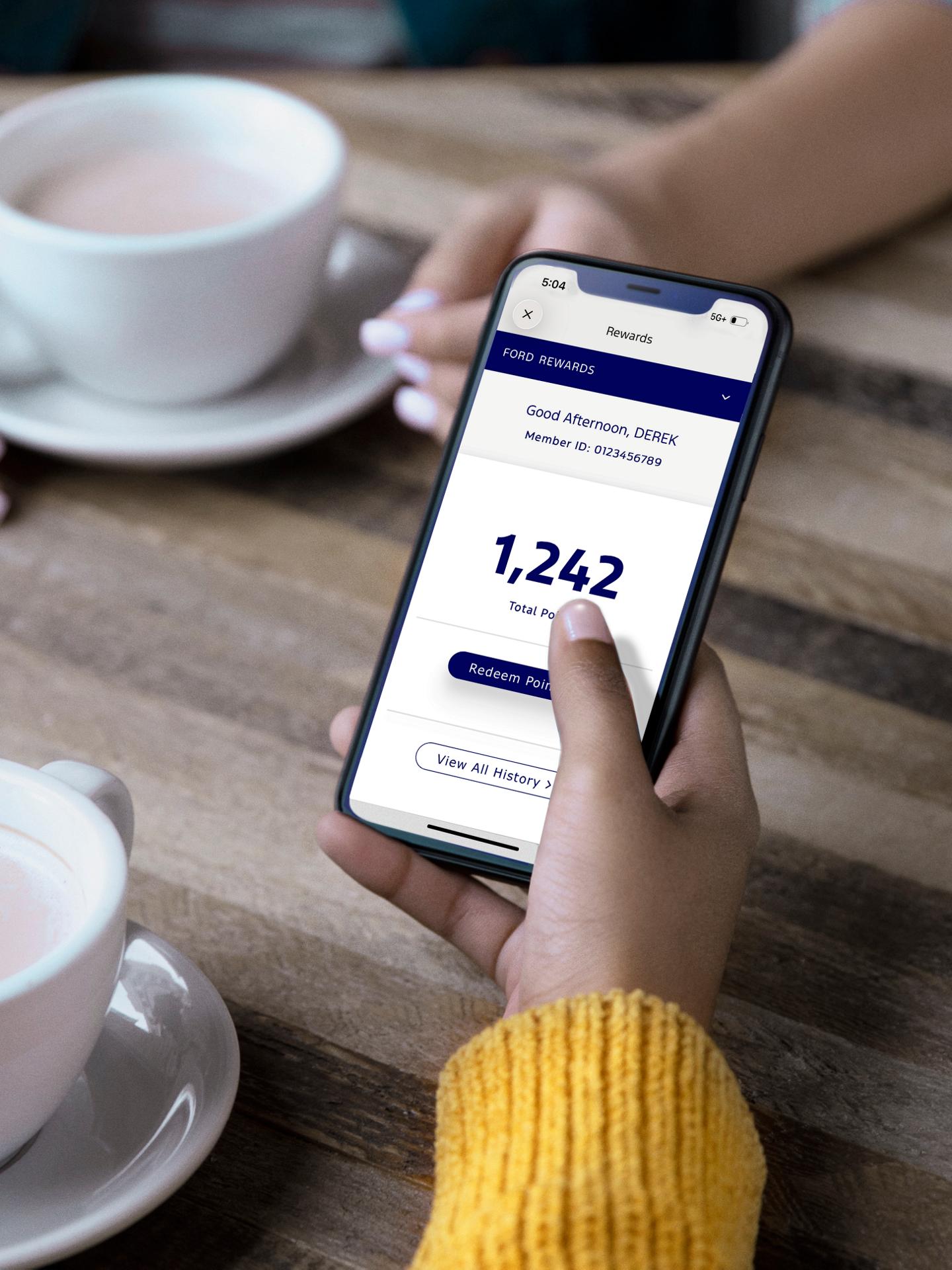 A phone displaying the Ford Rewards App.