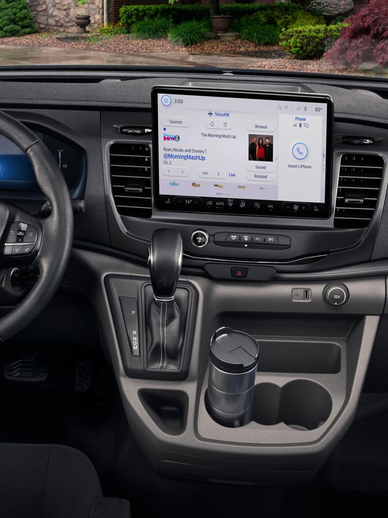 Dashboard and steering wheel of a Ford vehicle, featuring a large entertainment center screen and digital display