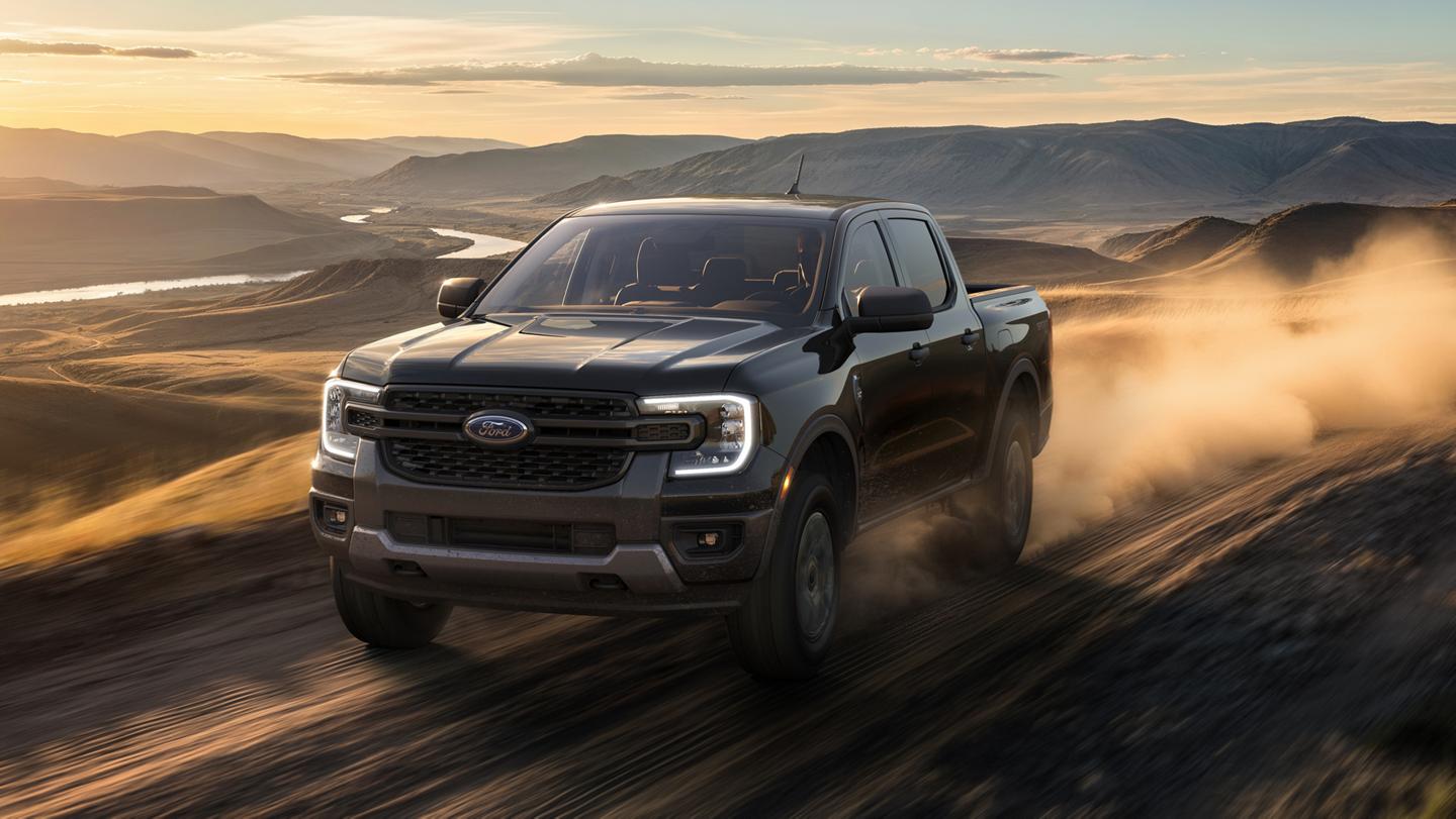 A 2026 Ford Ranger® XLT with the Sport Appearance Package being driven in a desert at dusk