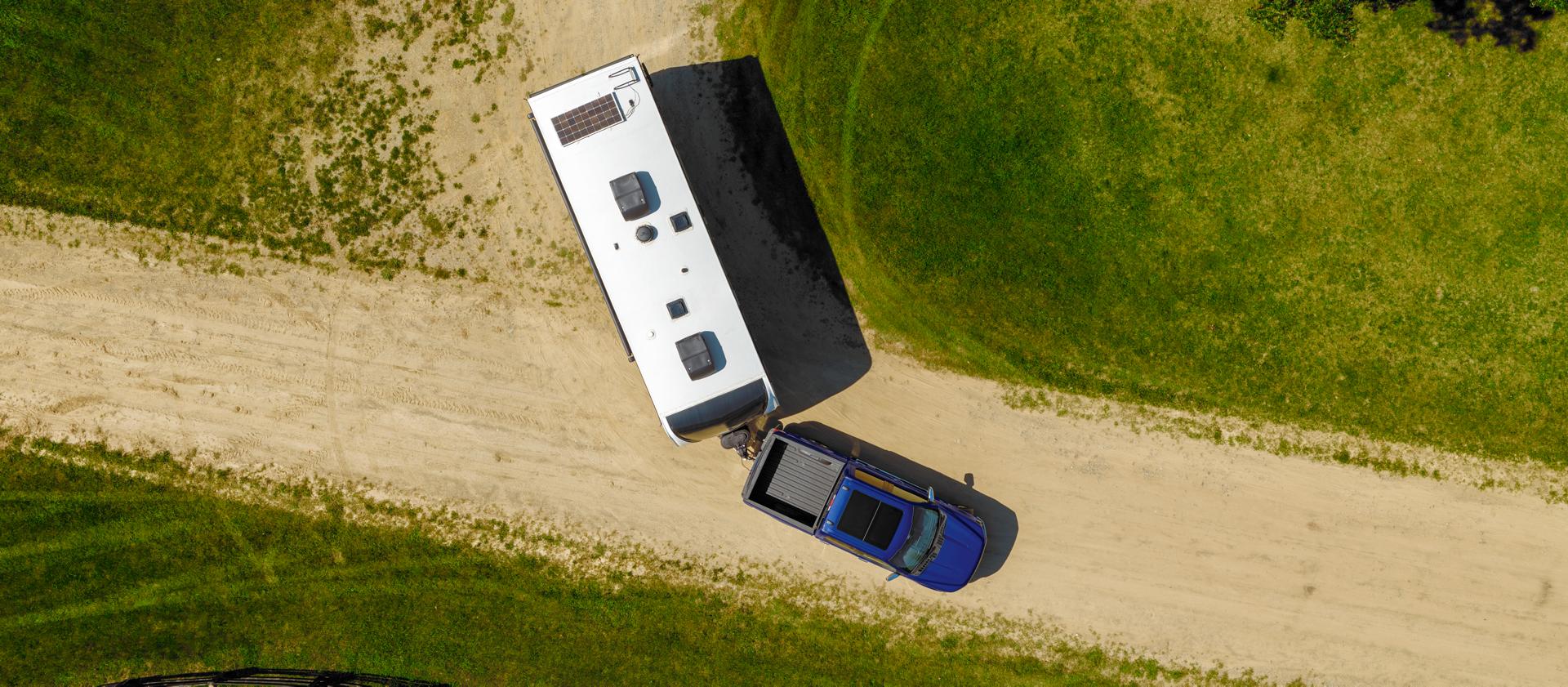 Arial view of a 2026 Ford F-150 pickup pulling a large camper