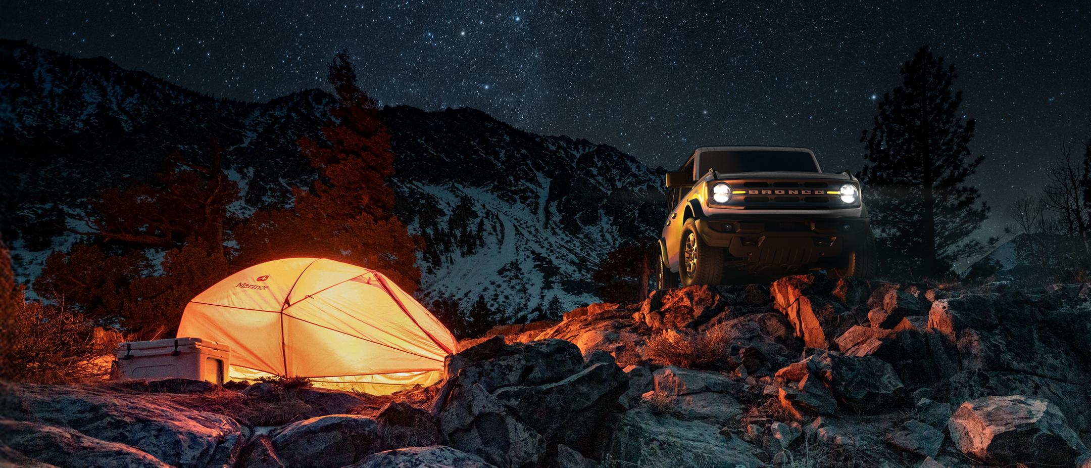 Bronco parked on a rocky hill.