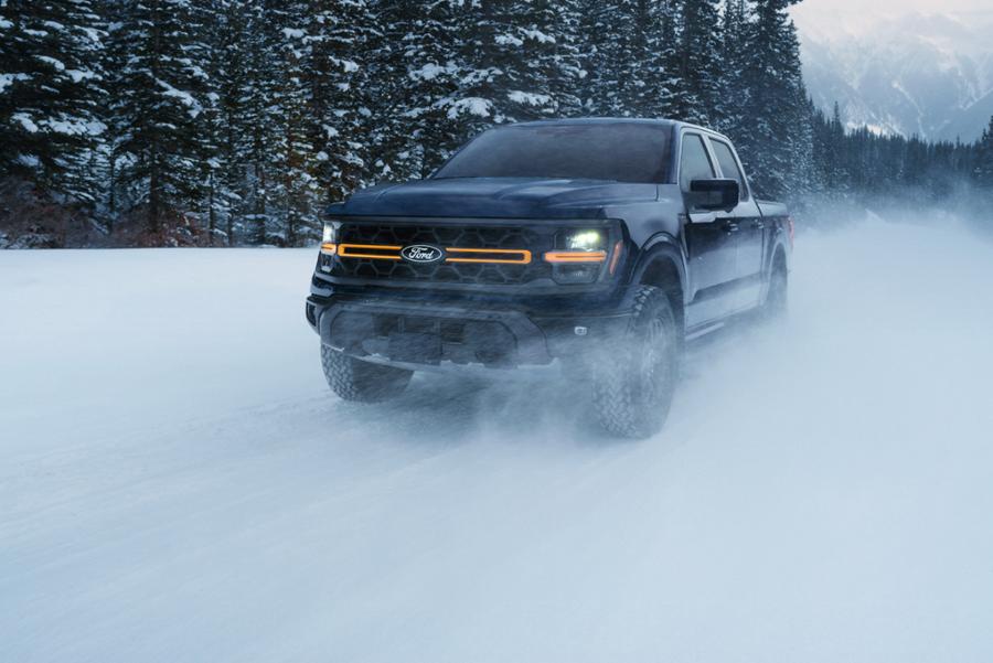 Front view of an F-150 Tremor driving on a snowy mountain road.