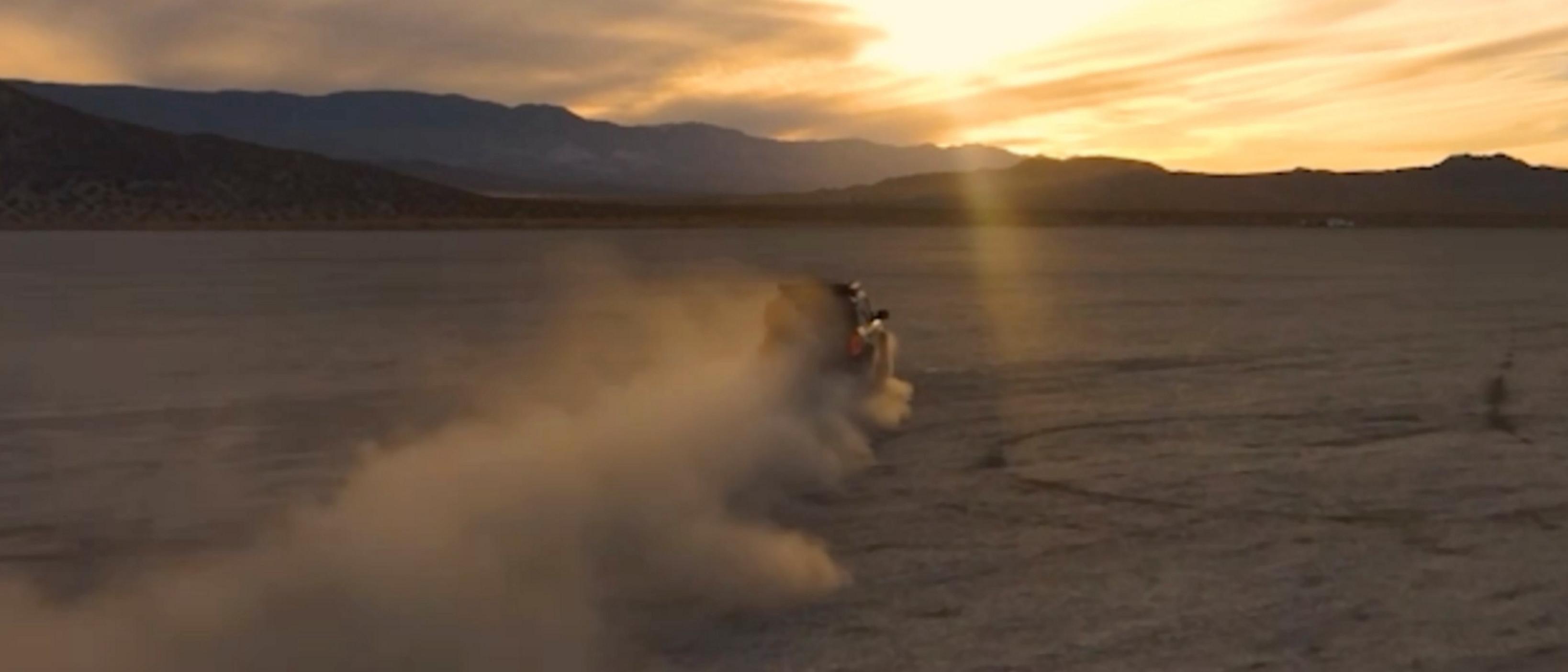 A 2026 Ford Bronco® SUV being driven in a dusty desert at sunset