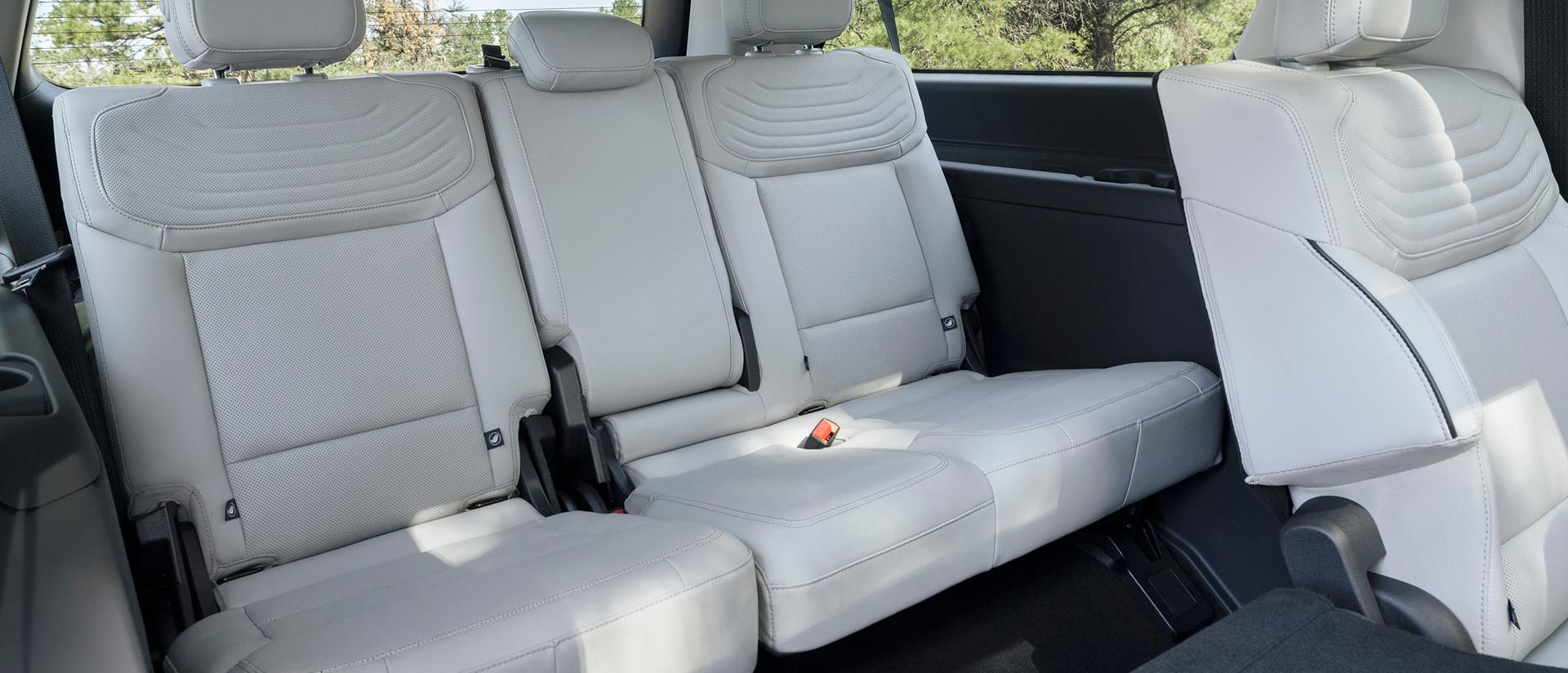 2027 Ford Expedition® Platinum™ SUV rear seating area with a seat folded flat