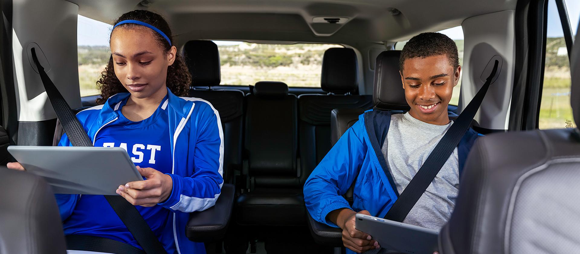 Two passengers in the second row using tablets in a 2027 Ford Expedition® SUV
