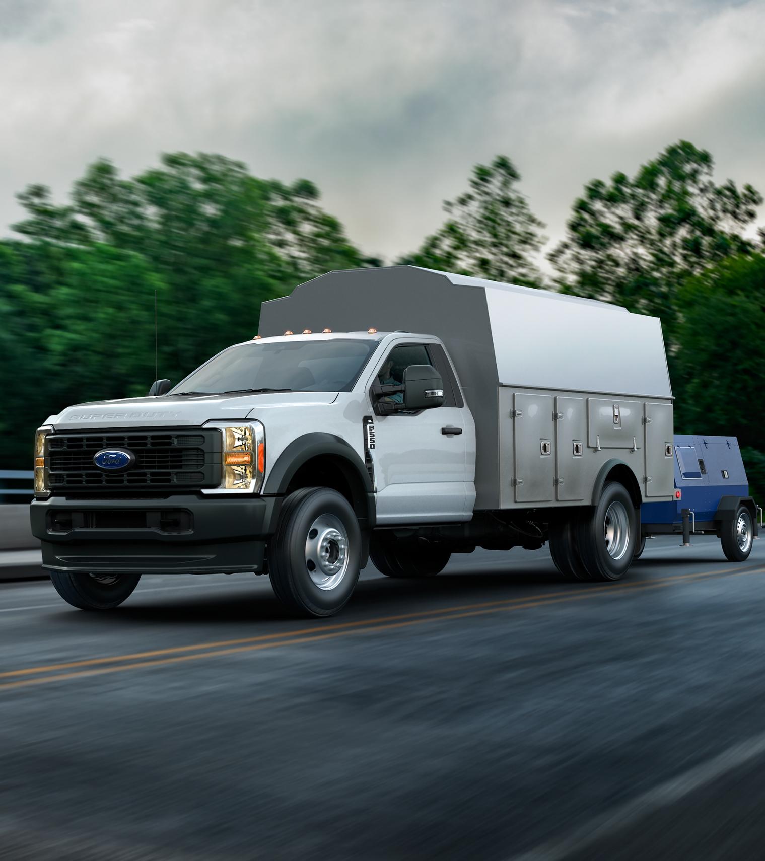 A 2026 Ford Super Duty® Chassis Cab with a utility box towing a generator