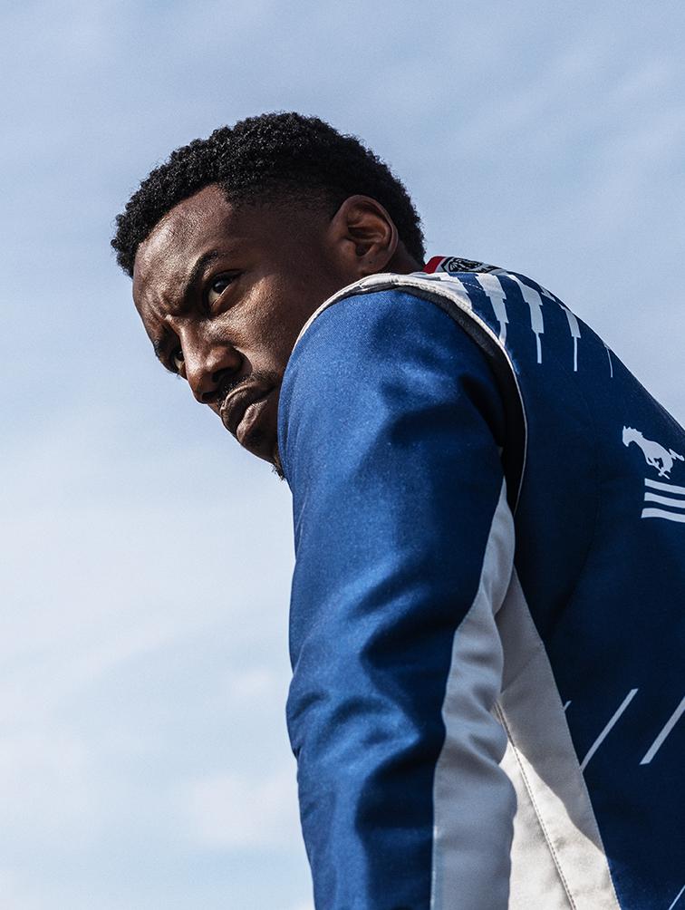 Determined-looking person in a driver kit.