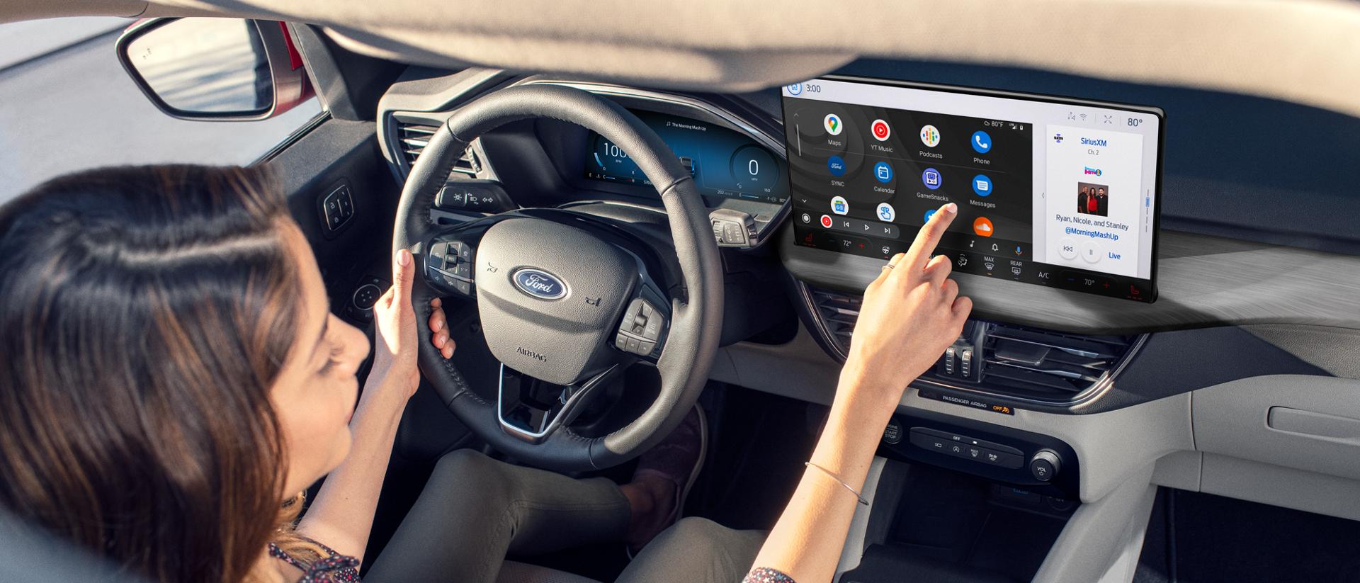 A woman driving a Ford vehicle.