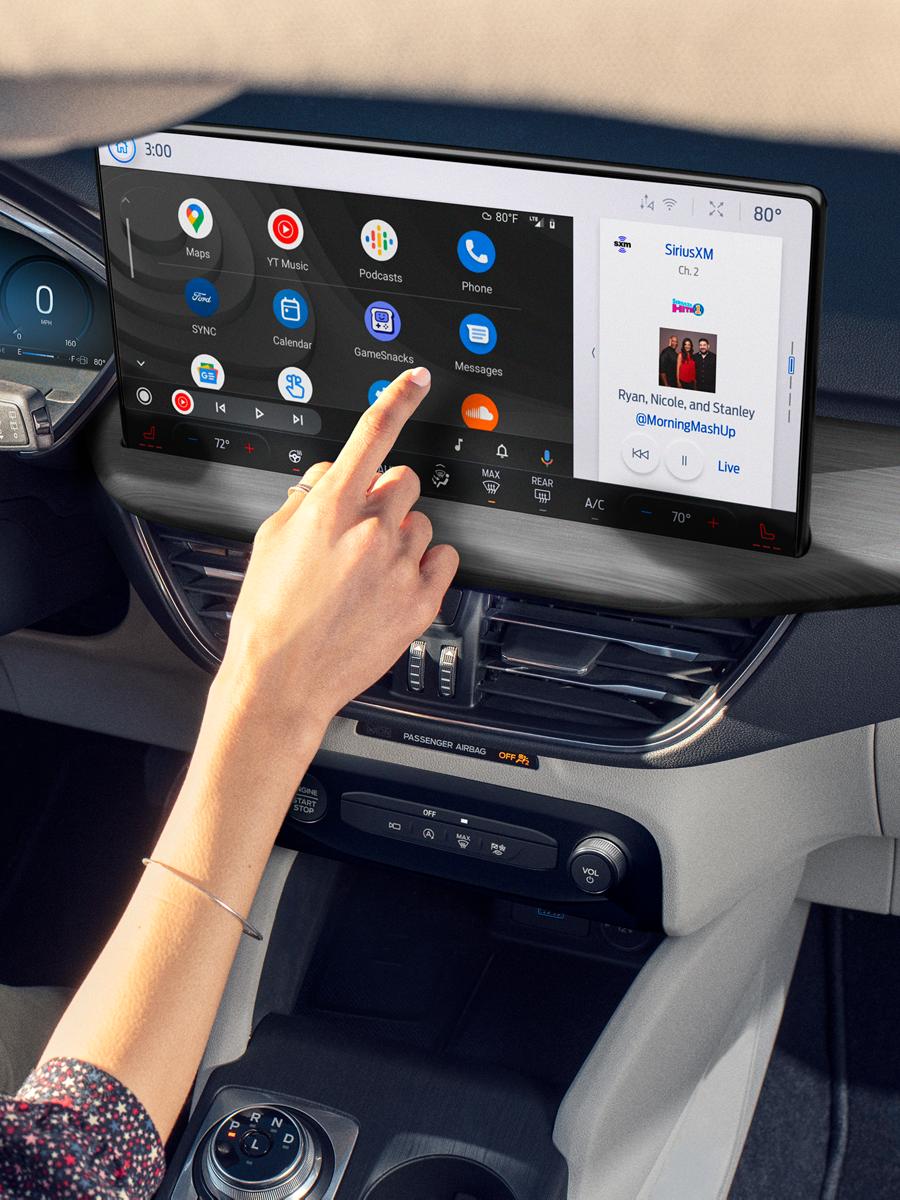 A woman driving a Ford vehicle.