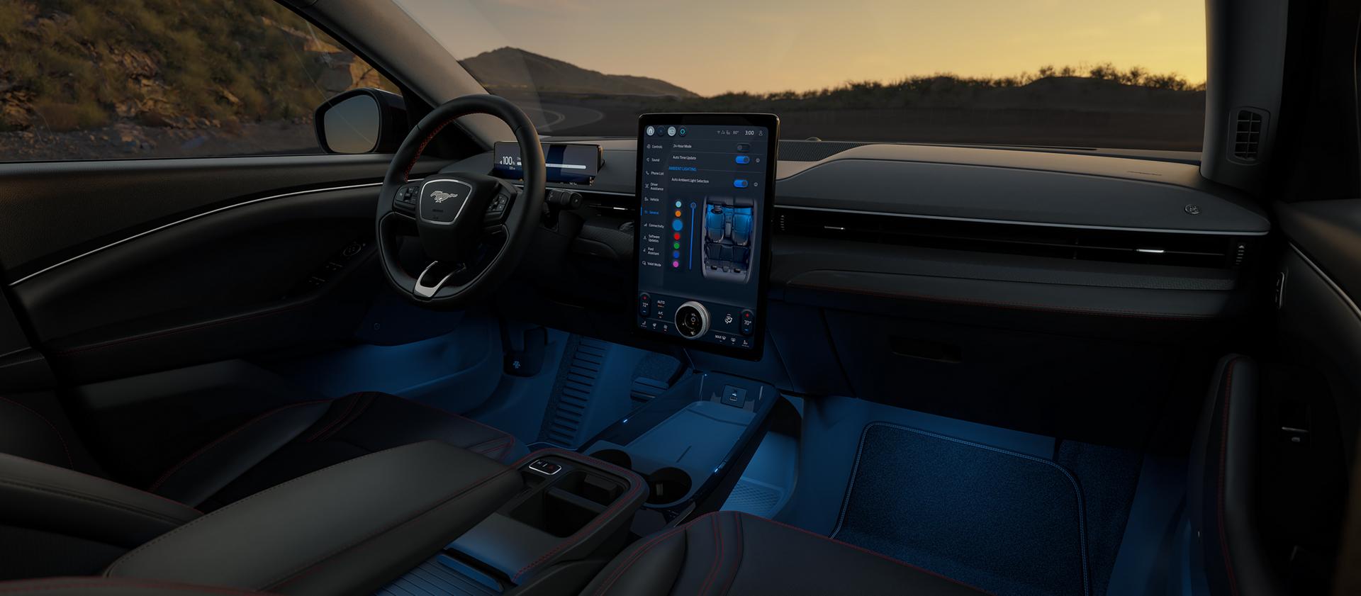 Interior of a 2026 Ford Mustang Mach-E® SUV with a view of the driver's seat, dashboard, and scenic mountain landscape