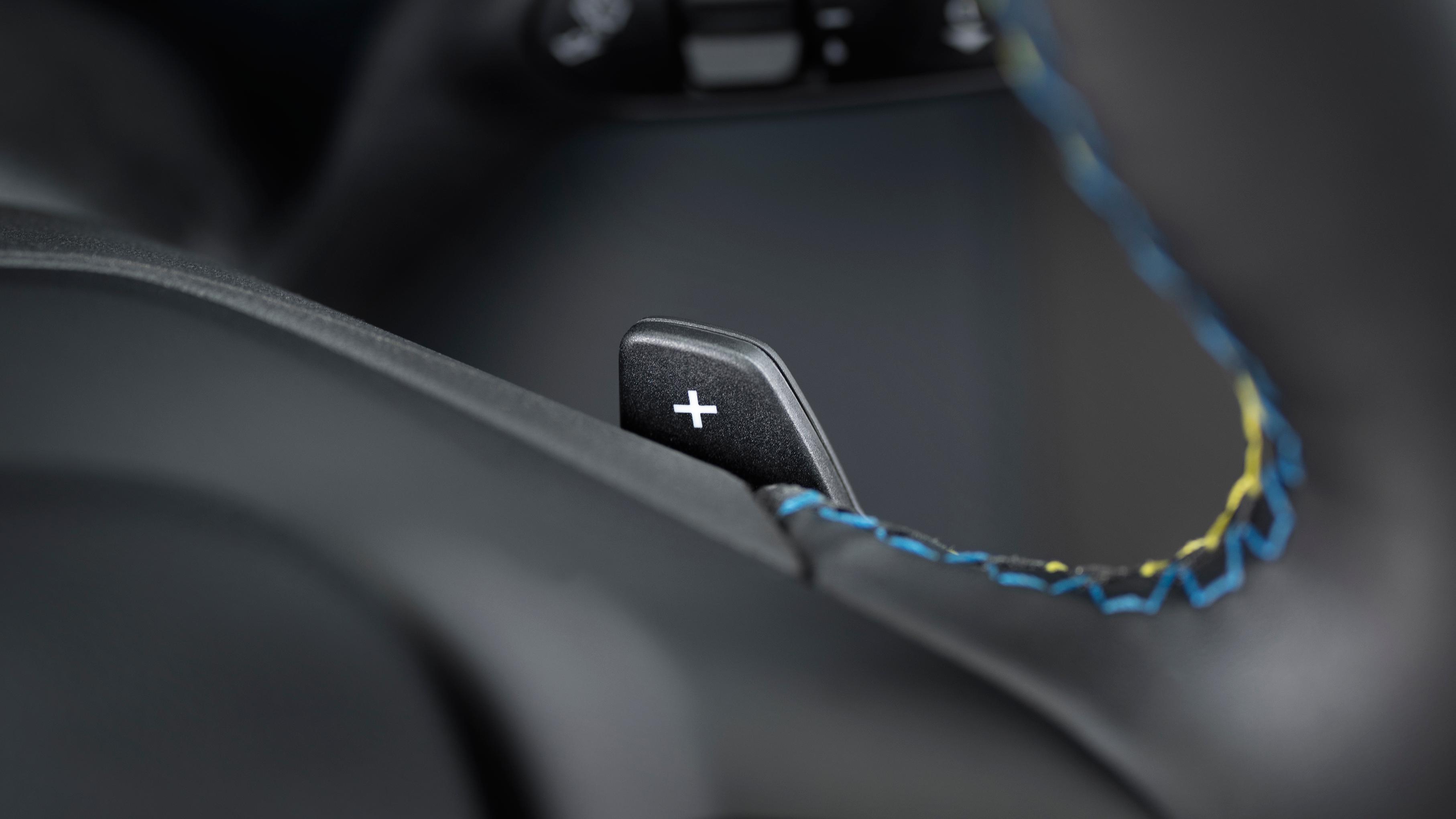 Close-up of the paddle shifter and accent stitching on the steering wheel of a 2026 Ford Maverick® Lobo™ pickup