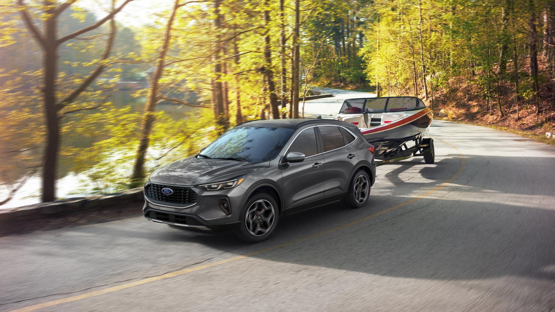 2026 Ford Escape® SUV towing a boat on a curved highway