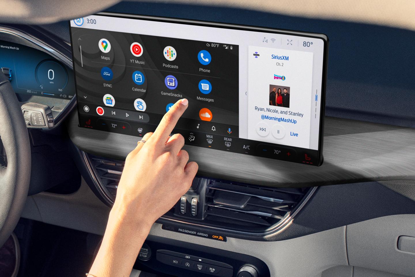 Person interacting with the centre touch screen in a Ford vehicle.