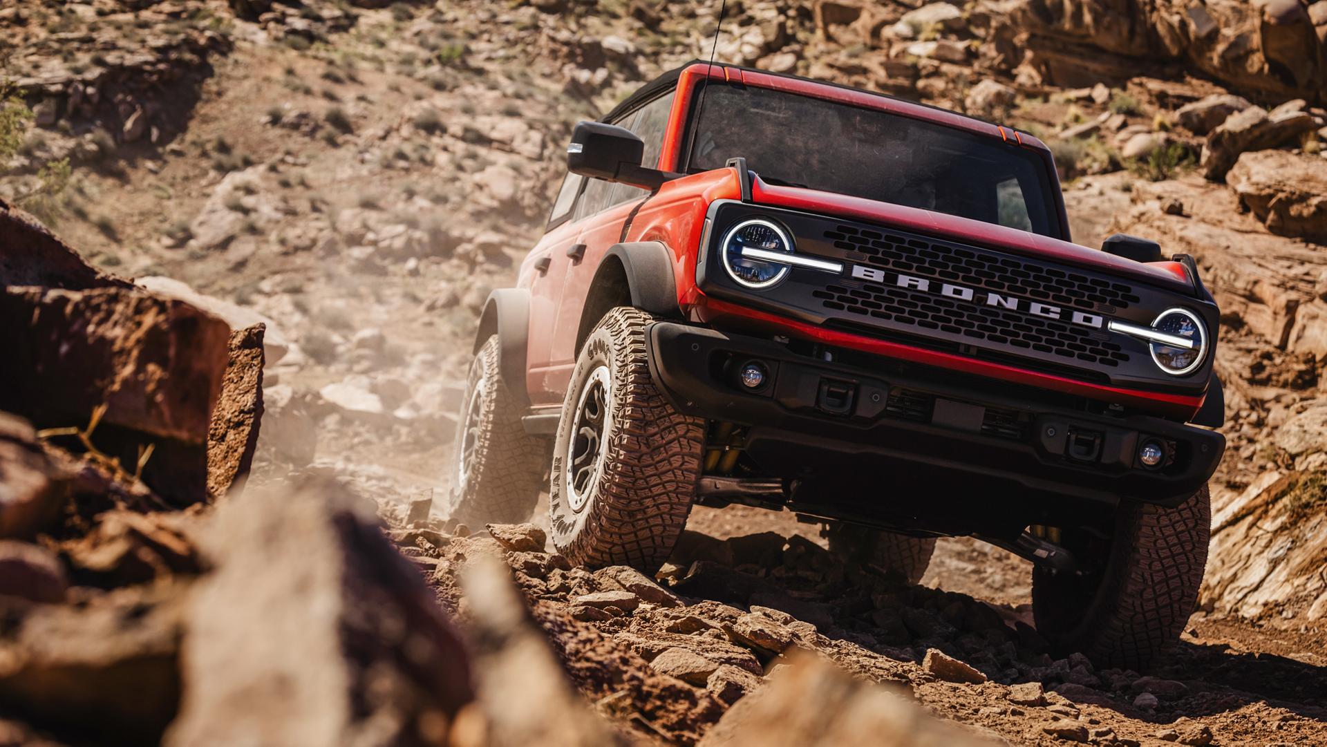 A 2025 Ford Bronco® SUV driving on a muddy hillside