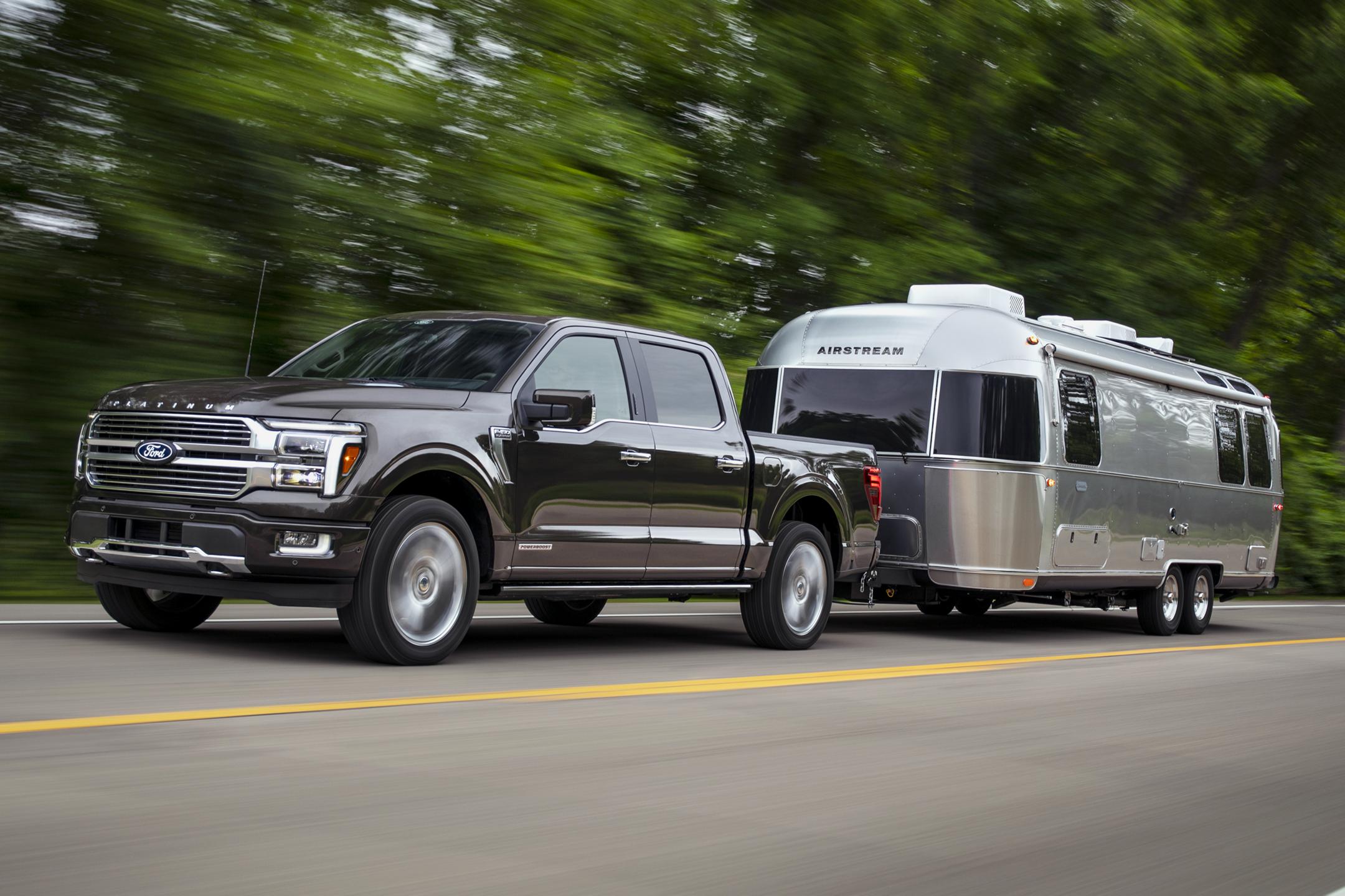 F-150 towing an RV on a two-lane highway.
