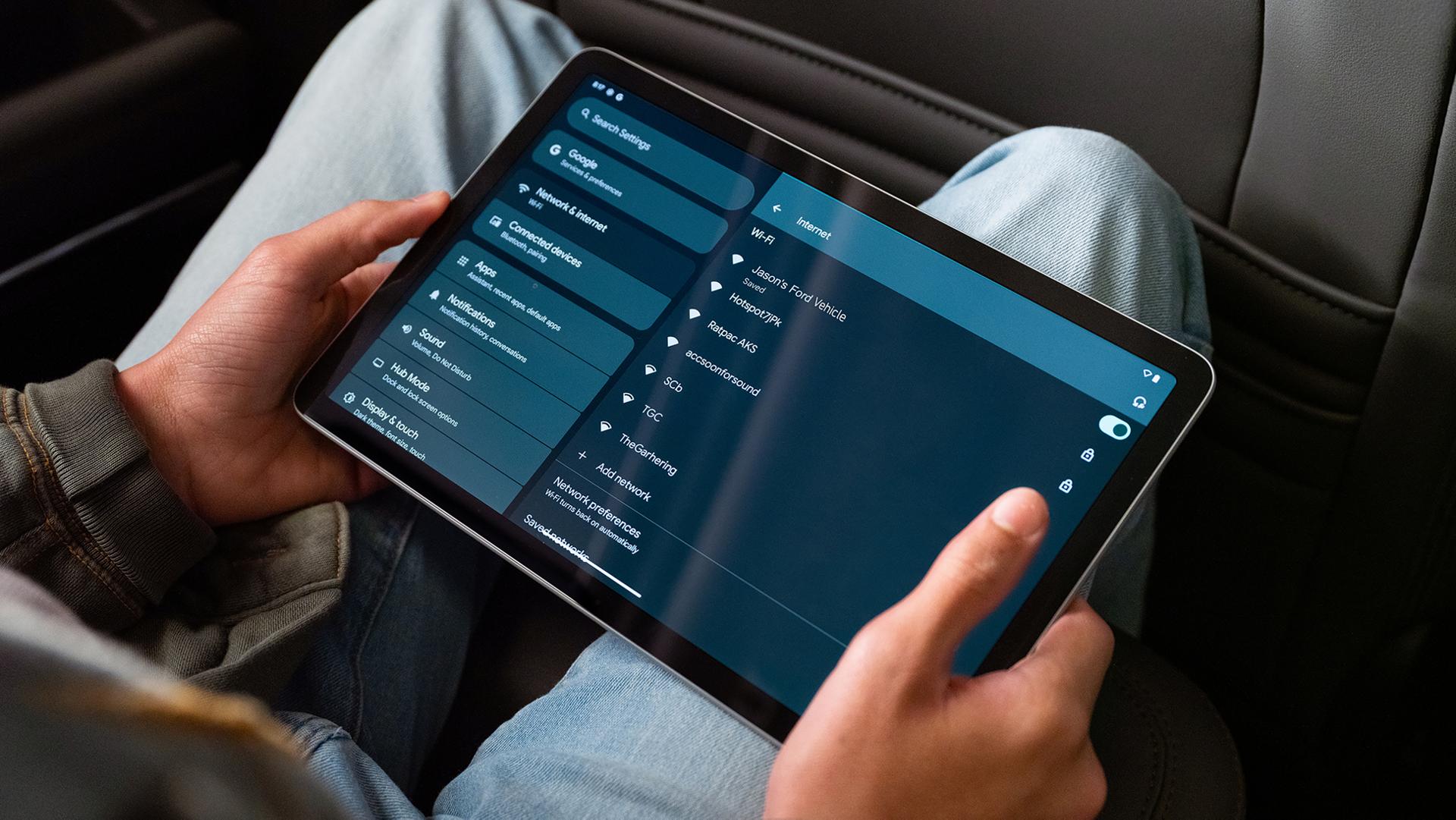 A passenger in a 2026 Ford Bronco® SUV using a tablet computer