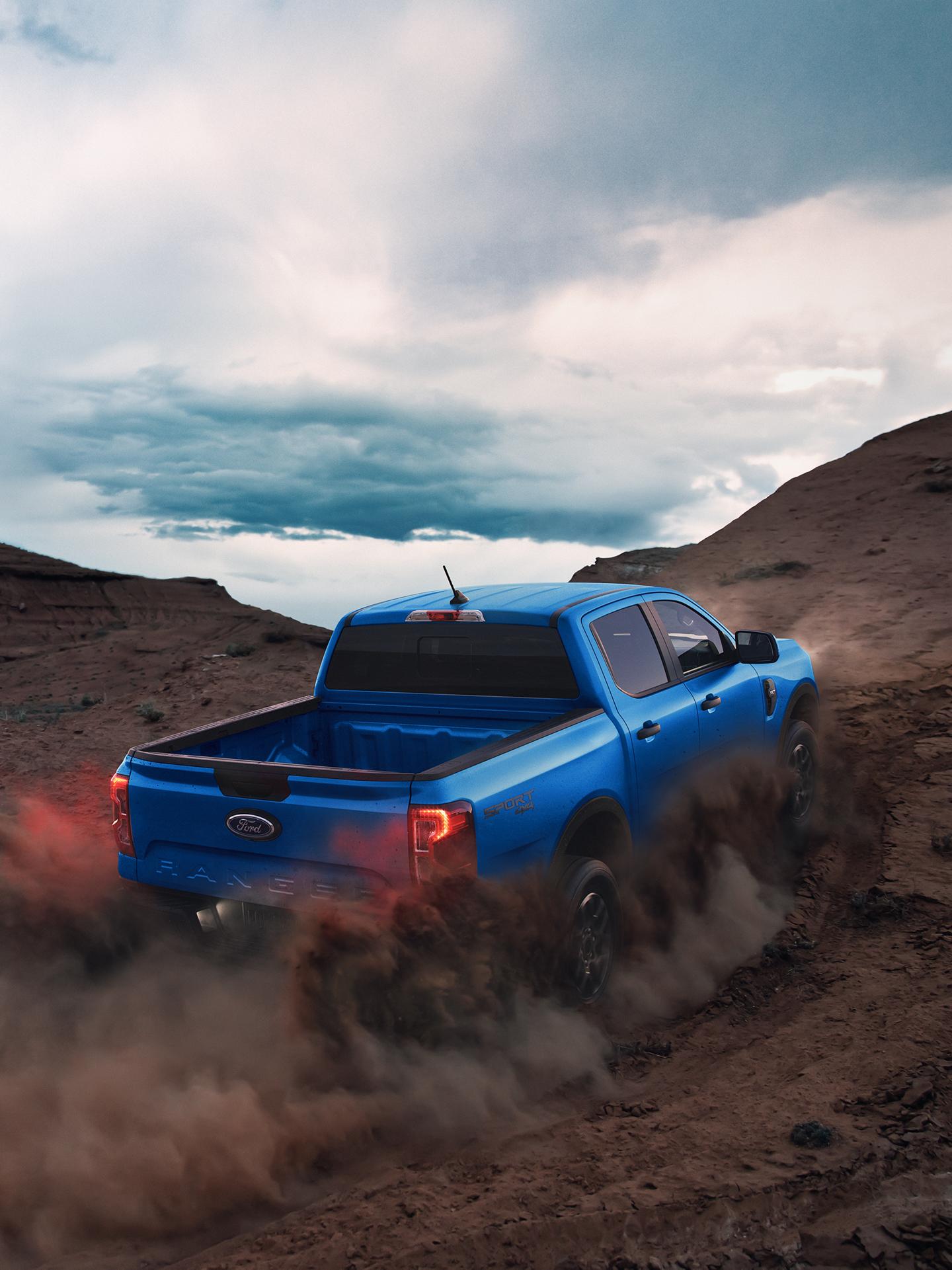 2026 Ford Ranger® XLT model kicking up dirt as it drives up a hill