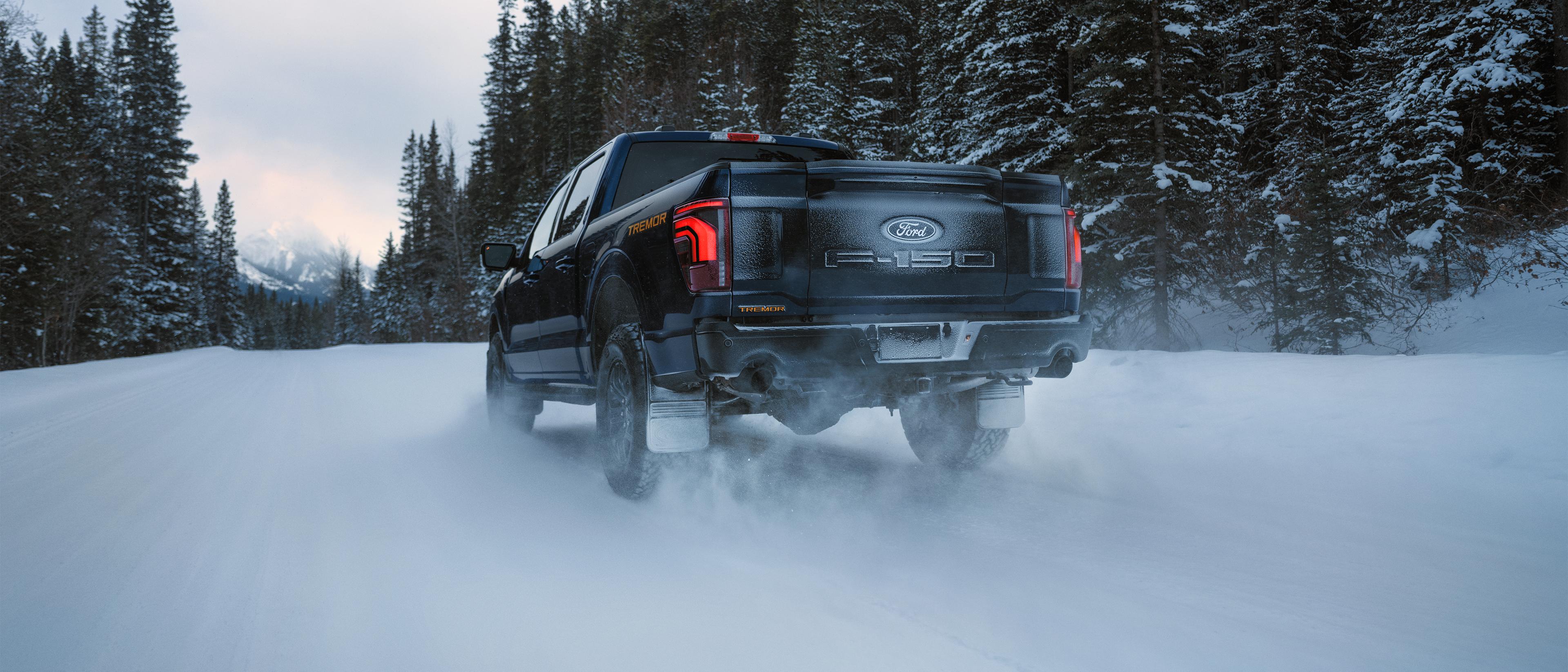 An F-150 Tremor driving on a snow-covered road.