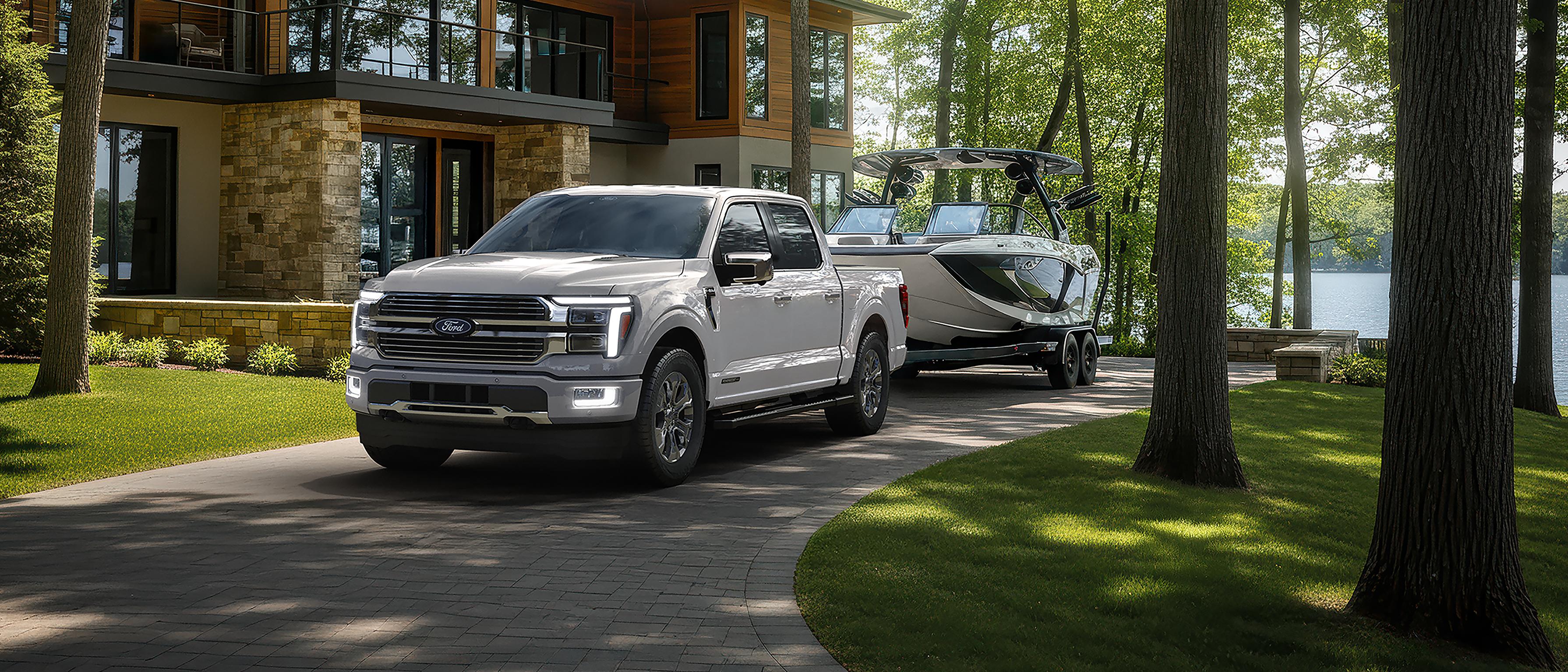 2026 Ford F-150® Platinum model with the Satin Package pulling a small trailer on a country road