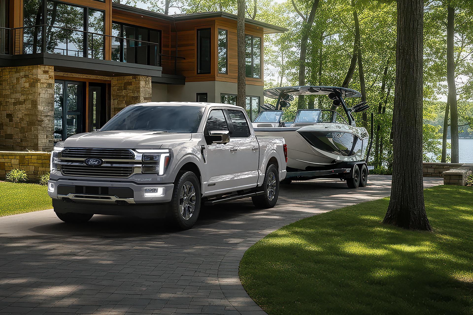 2026 Ford F-150® Platinum model with the Satin Package pulling a small trailer on a country road