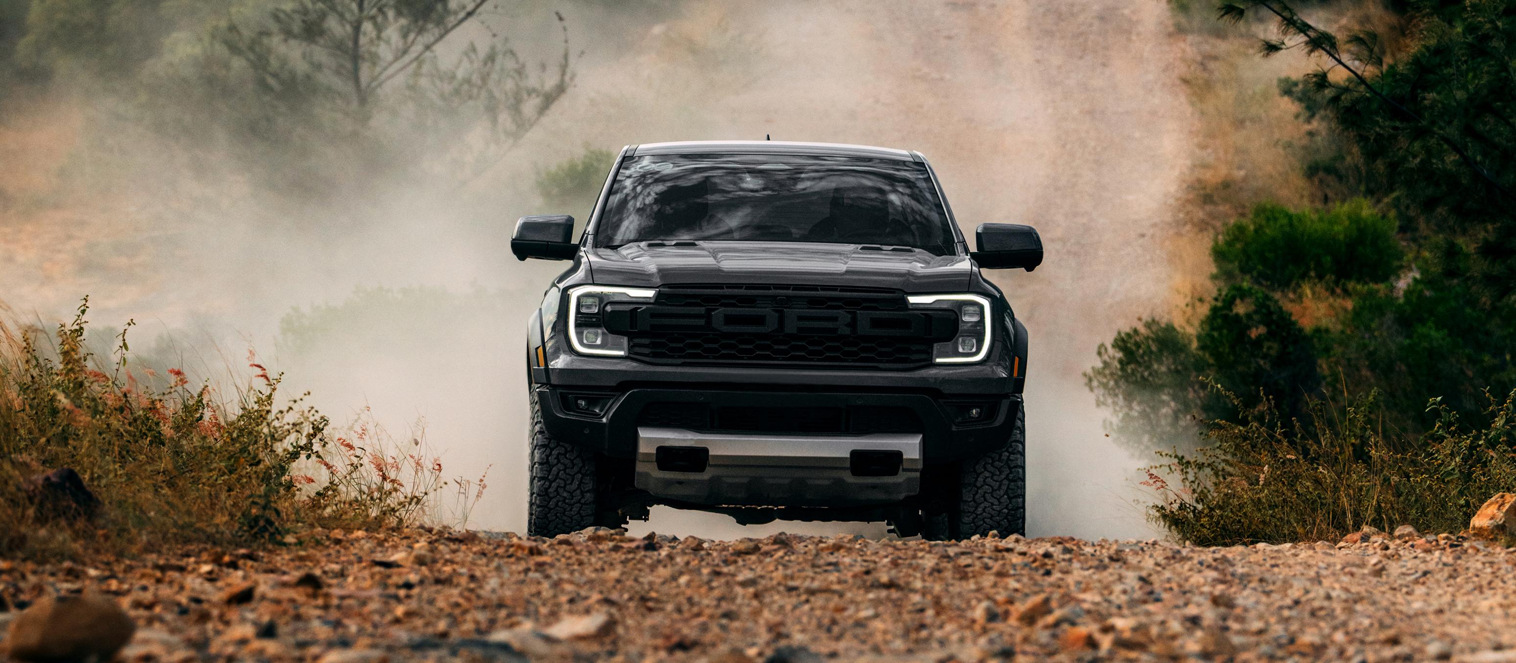 2026 Ford Ranger Raptor® model kicking up dirt while off-road driving