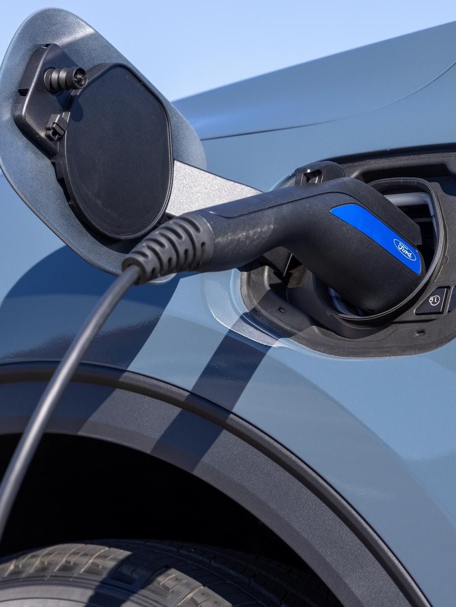 Ford vehicle with charging cable plugged in.