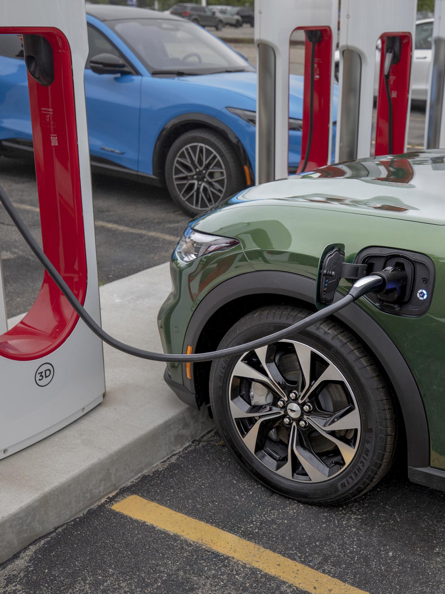 Mustang Mach-E plugged into a public Tesla Supercharger.