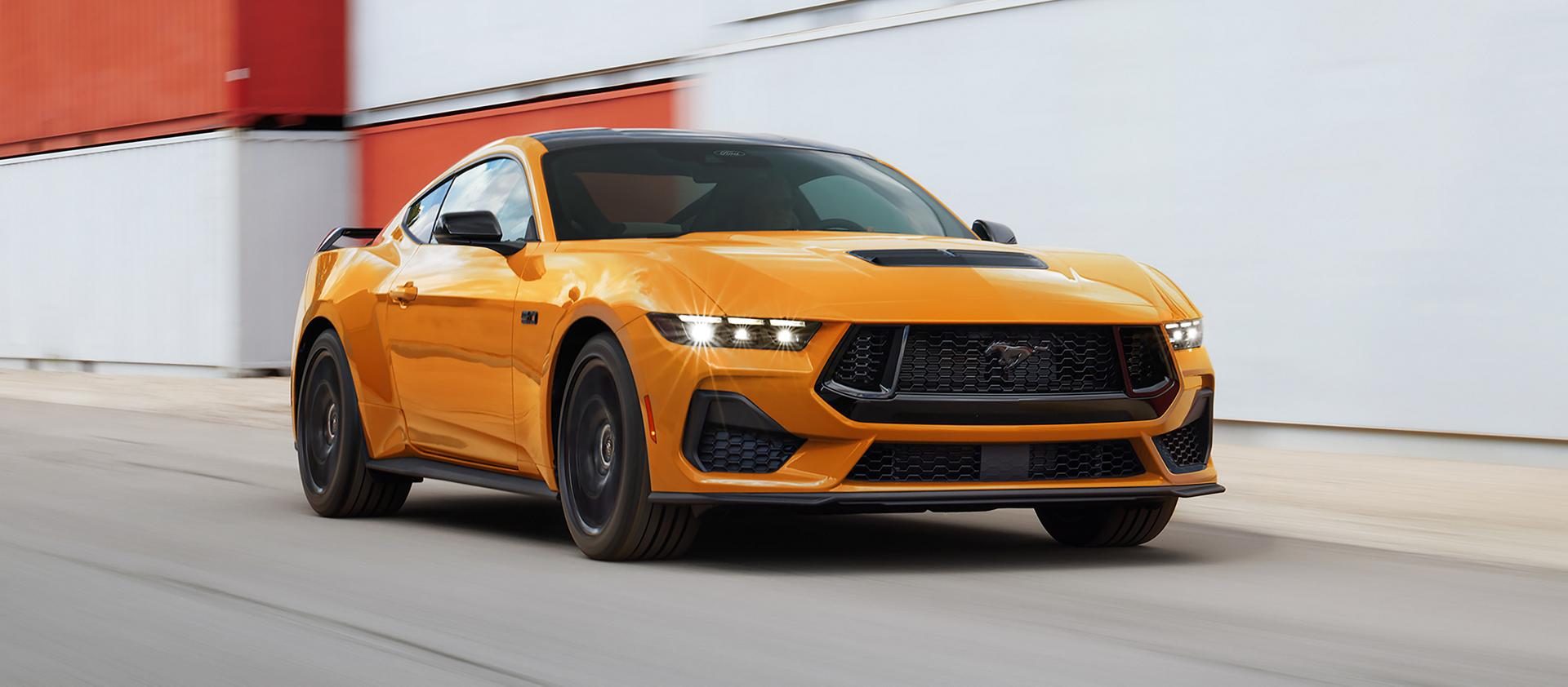 2026 Ford Mustang® GT model in Orange Fury Metallic Tri-coat being driven on a closed course