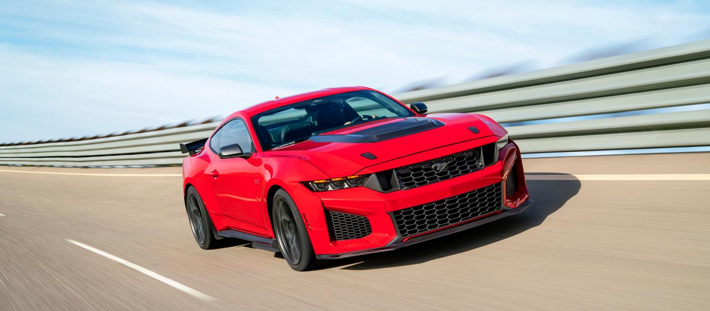 A 2026 Ford Mustang Dark Horse® SC with optional equipment driving on a closed track