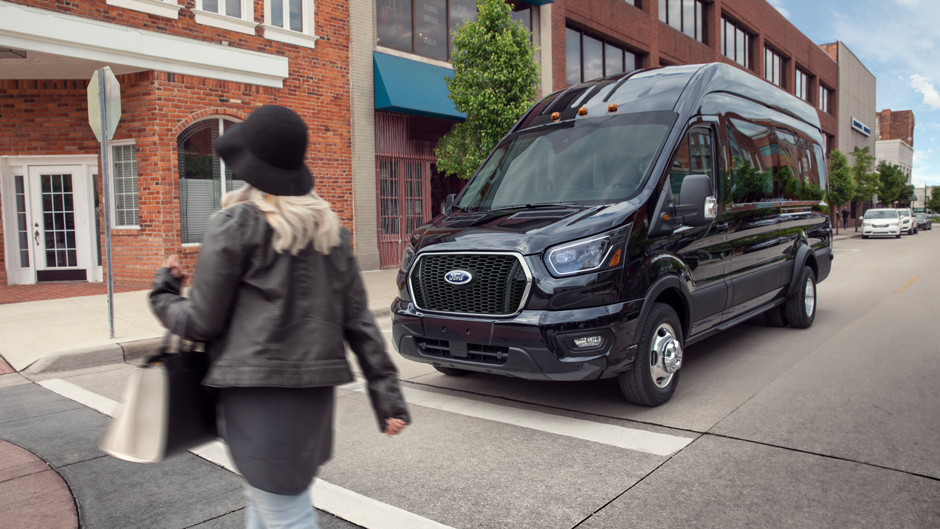 Two people camping with a 2026 Ford Transit® van in the background