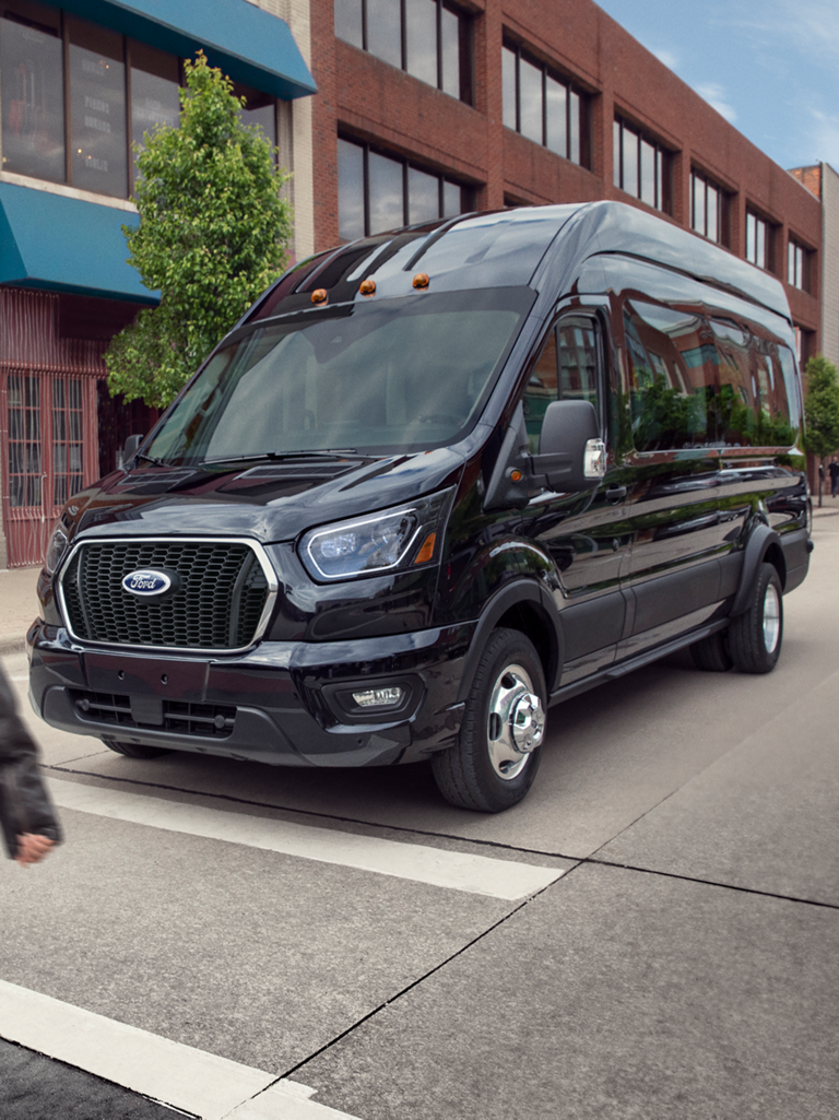 Two people camping with a 2026 Ford Transit® van in the background