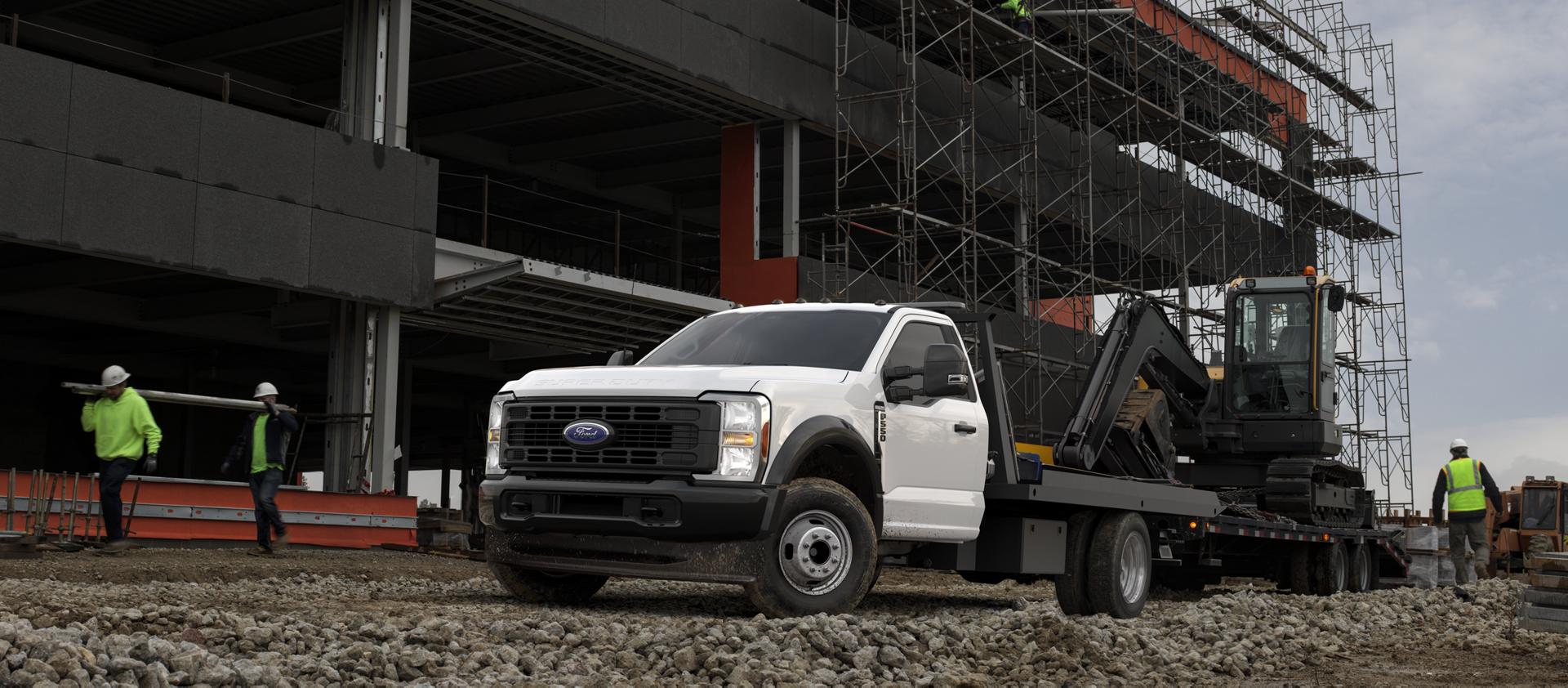 A 2026 Ford Super Duty® Chassis Cab towing an excavator