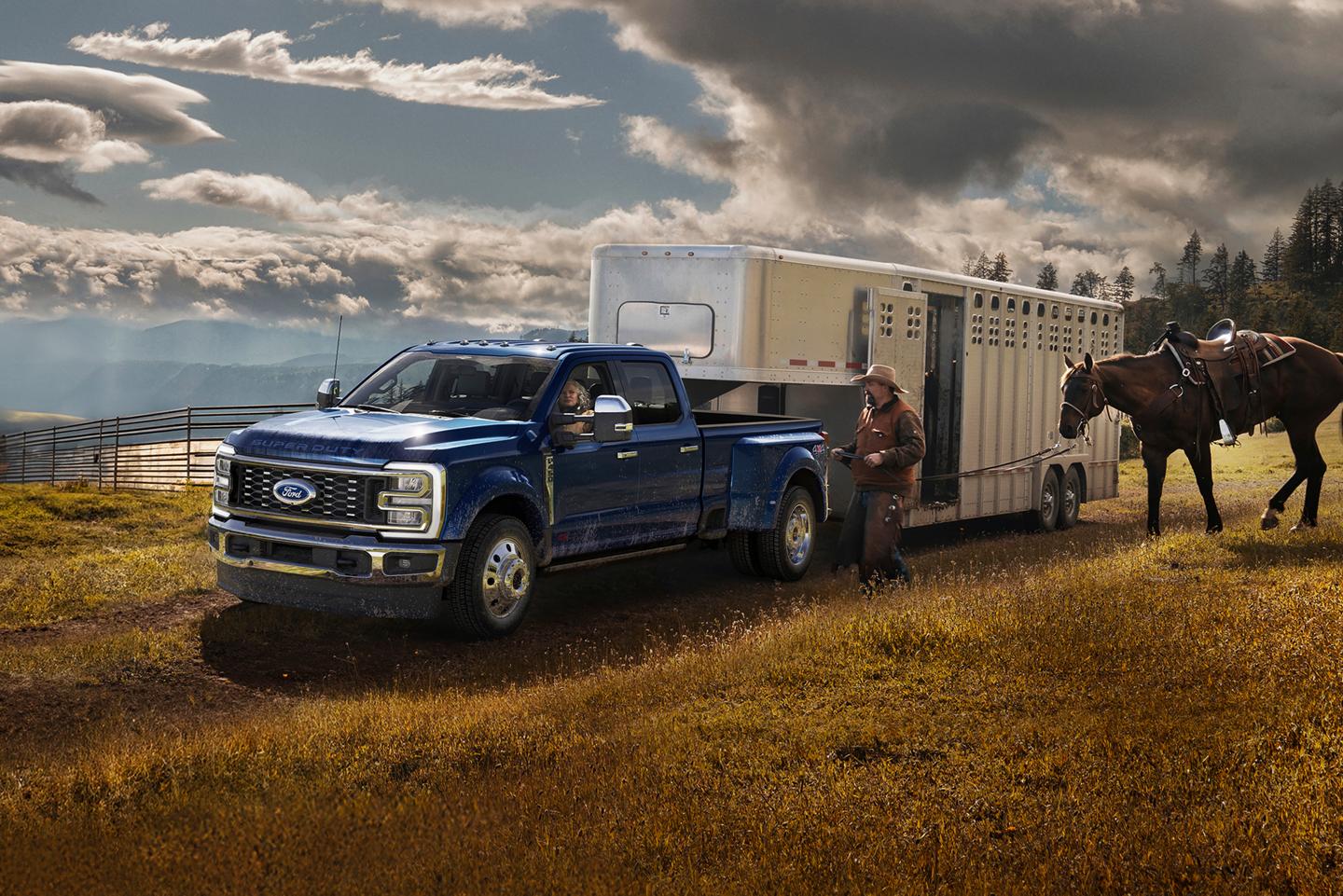 2026 Ford Super Duty® F-350 Lariat® in Argon Blue pulling a trailer down a road