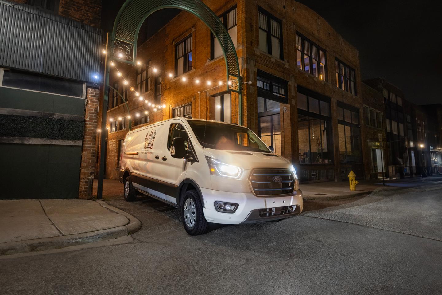 2026 Ford E-Transit™ Cargo Van pulling out of an alley in between buildings