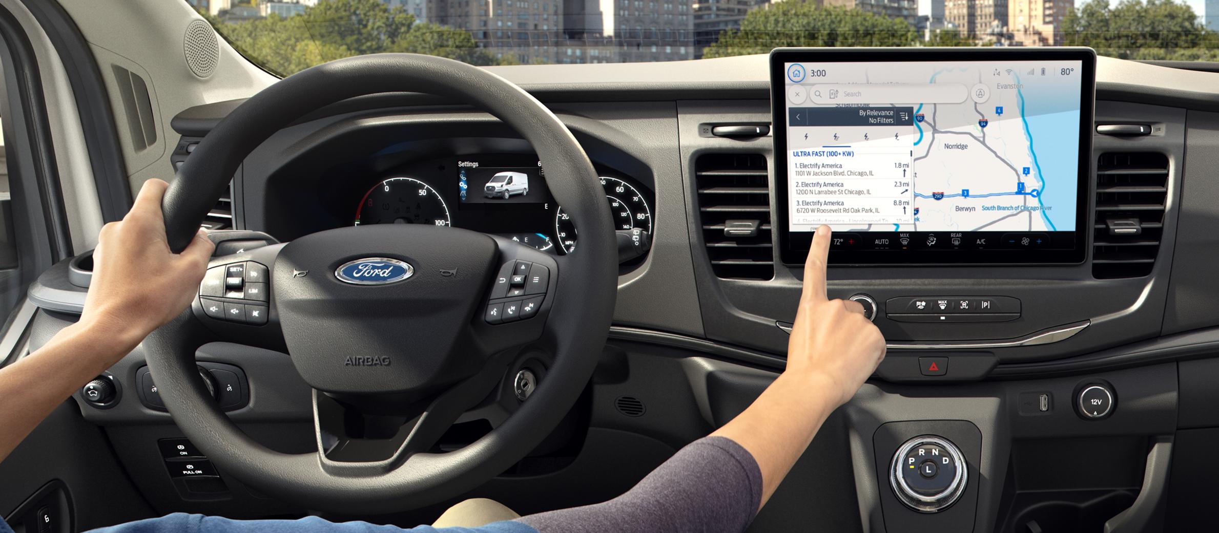 A driver parked and touching the interior computer screen