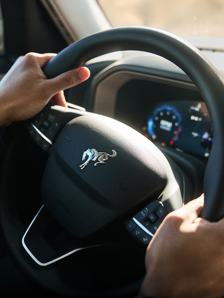 Close-up view of a driver holding a steering wheel inside the Bronco Sport® interior.