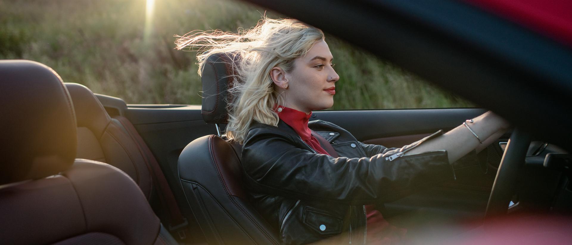 Person driving a 2026 Ford Mustang® GT convertible on a highway