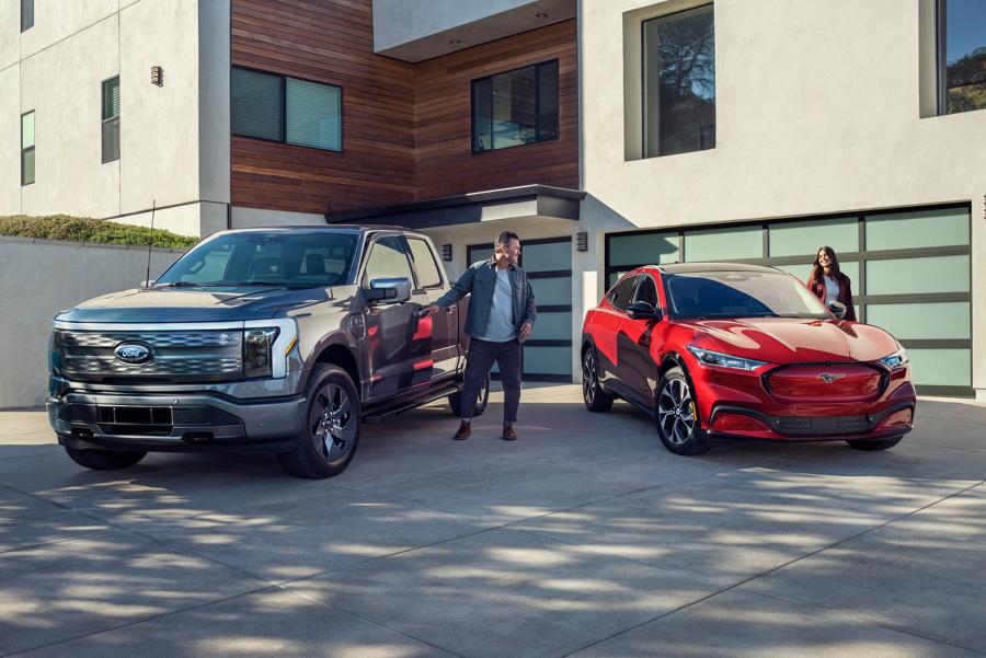 F-150 and Mustang Mach-E parked in front of a house.
