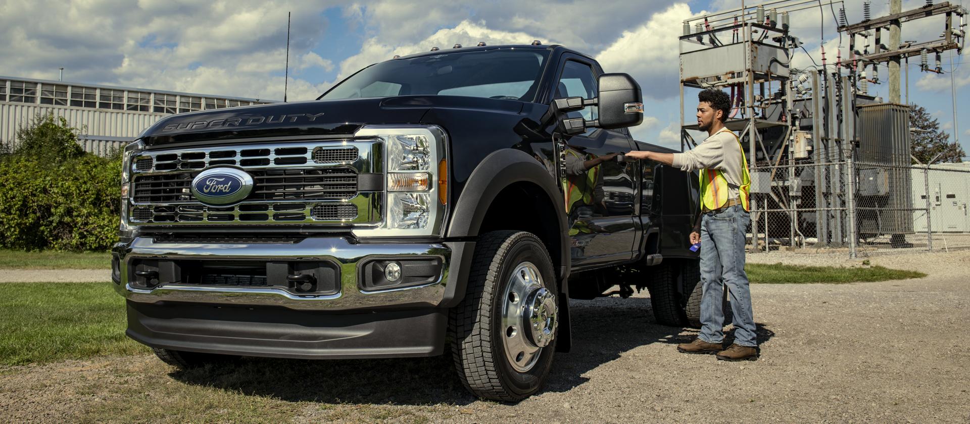 A person opening the driver door of their 2026 Ford Super Duty® F-450® XL model with the Chrome Appearance Package