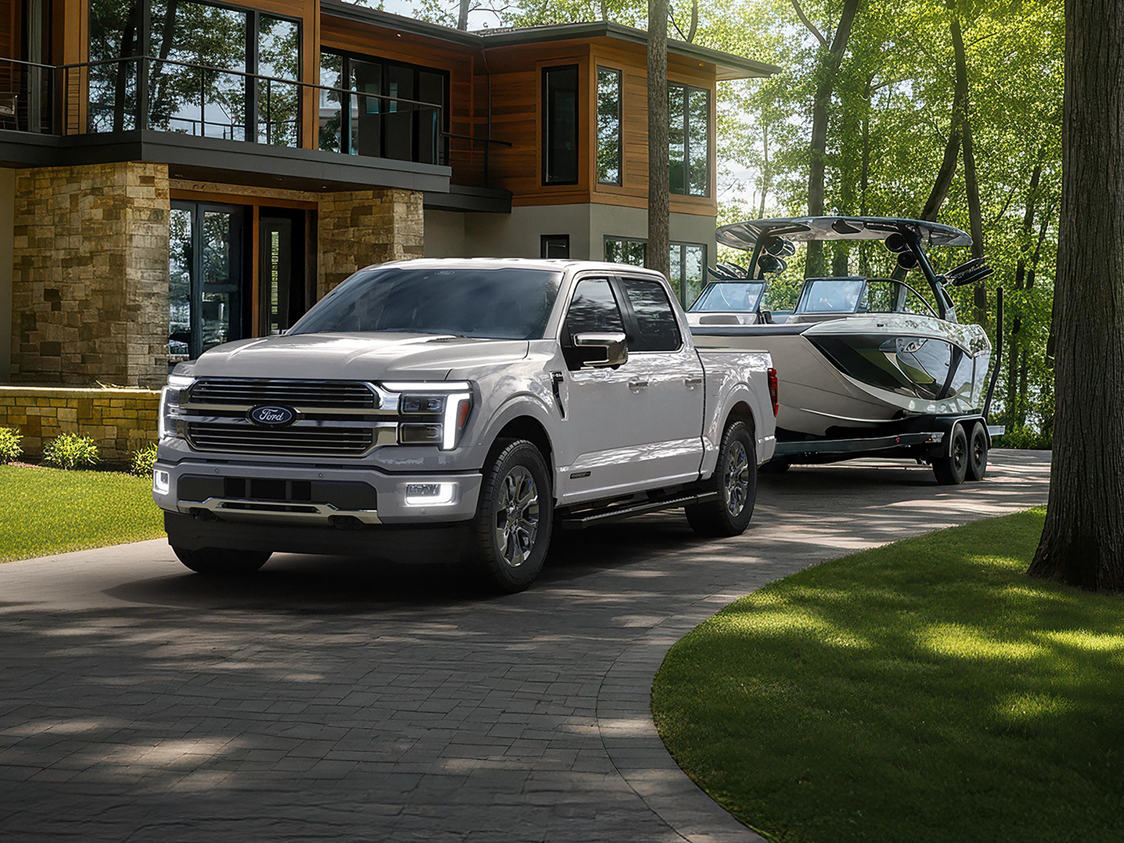 2026 Ford F-150® Platinum® model hitched to a boat trailer parked near a house