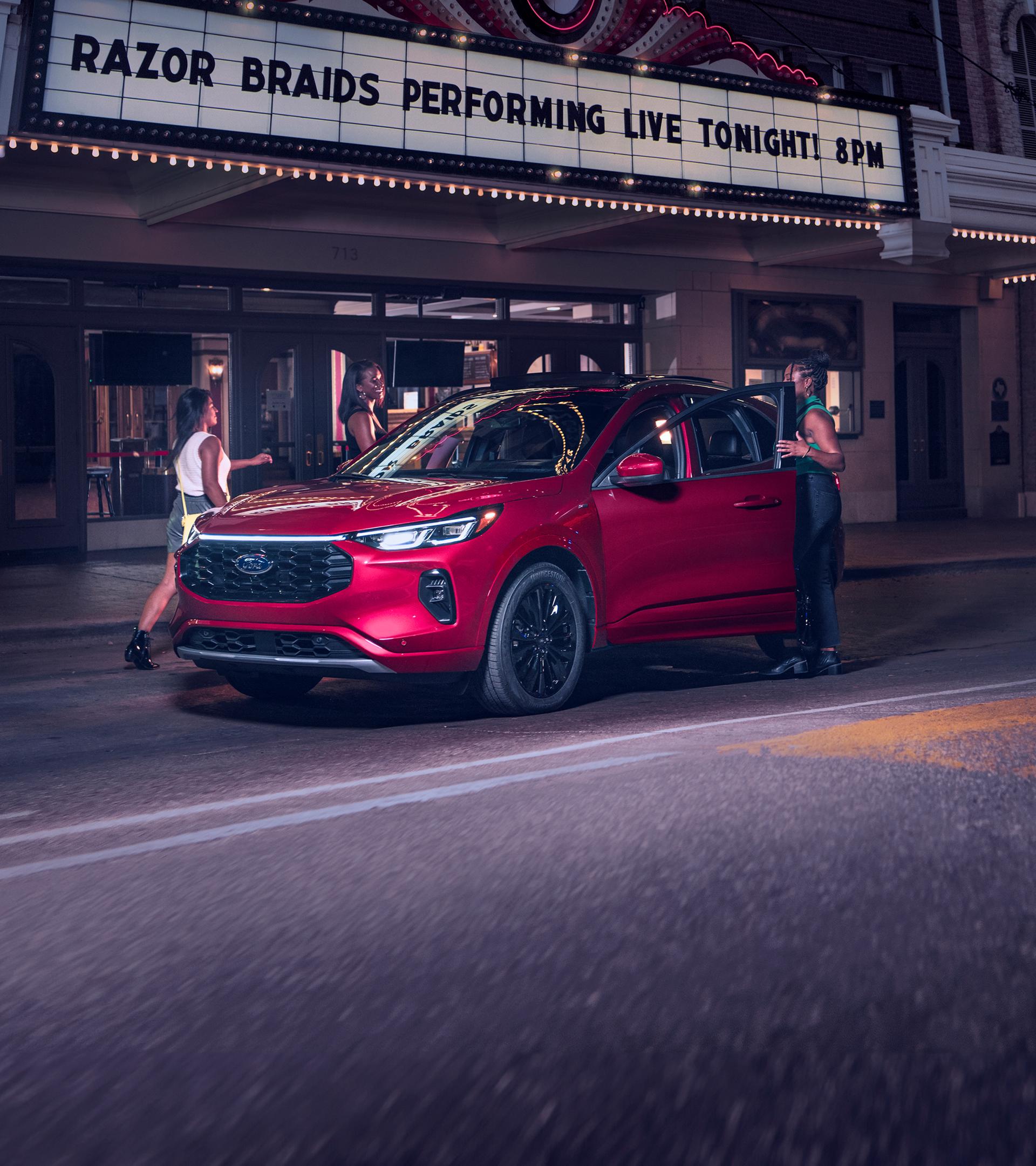 A red 2026 Ford Escape parked outside a theatre