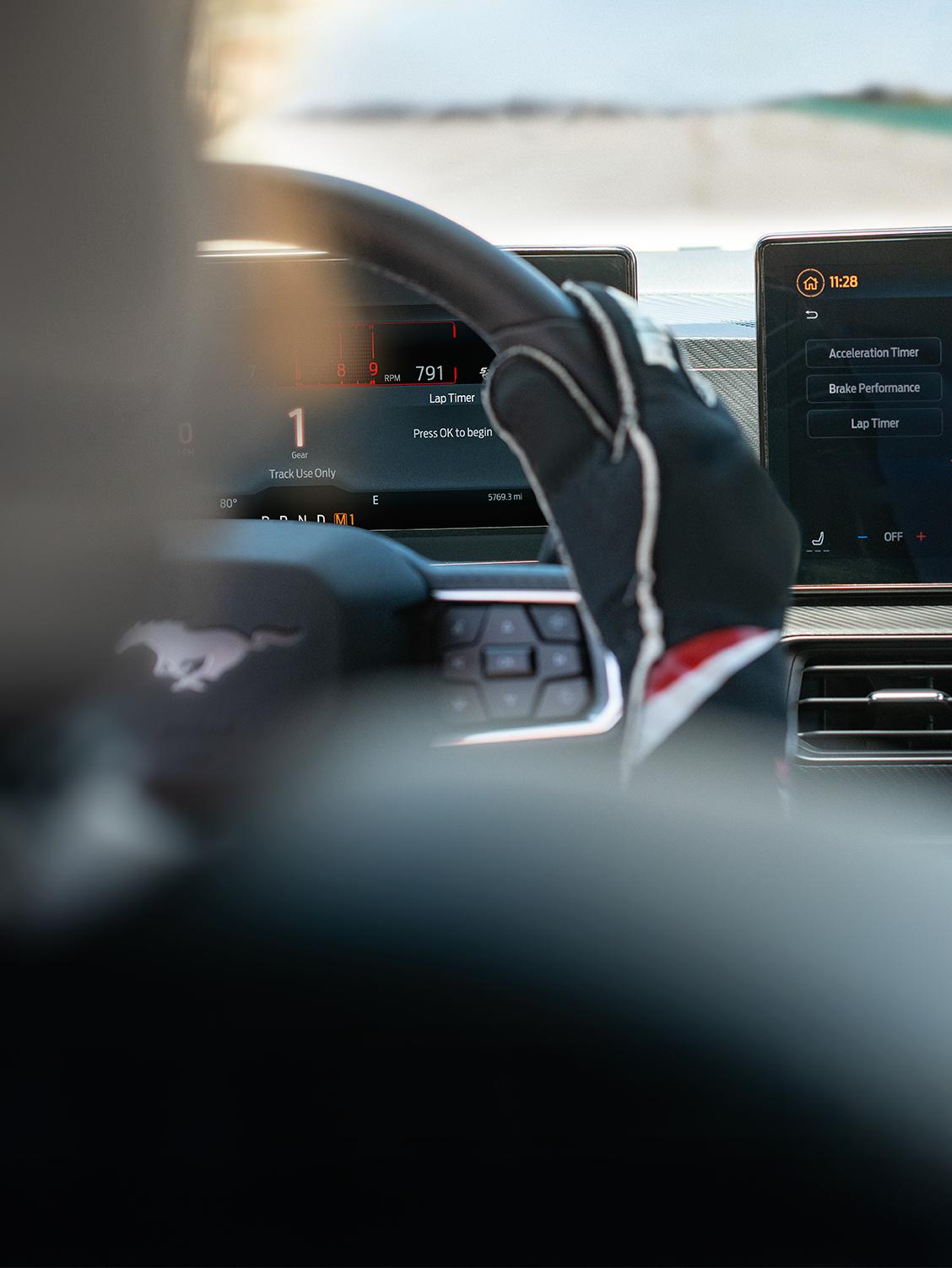 Interior view of a person driving a Ford performance vehicle.