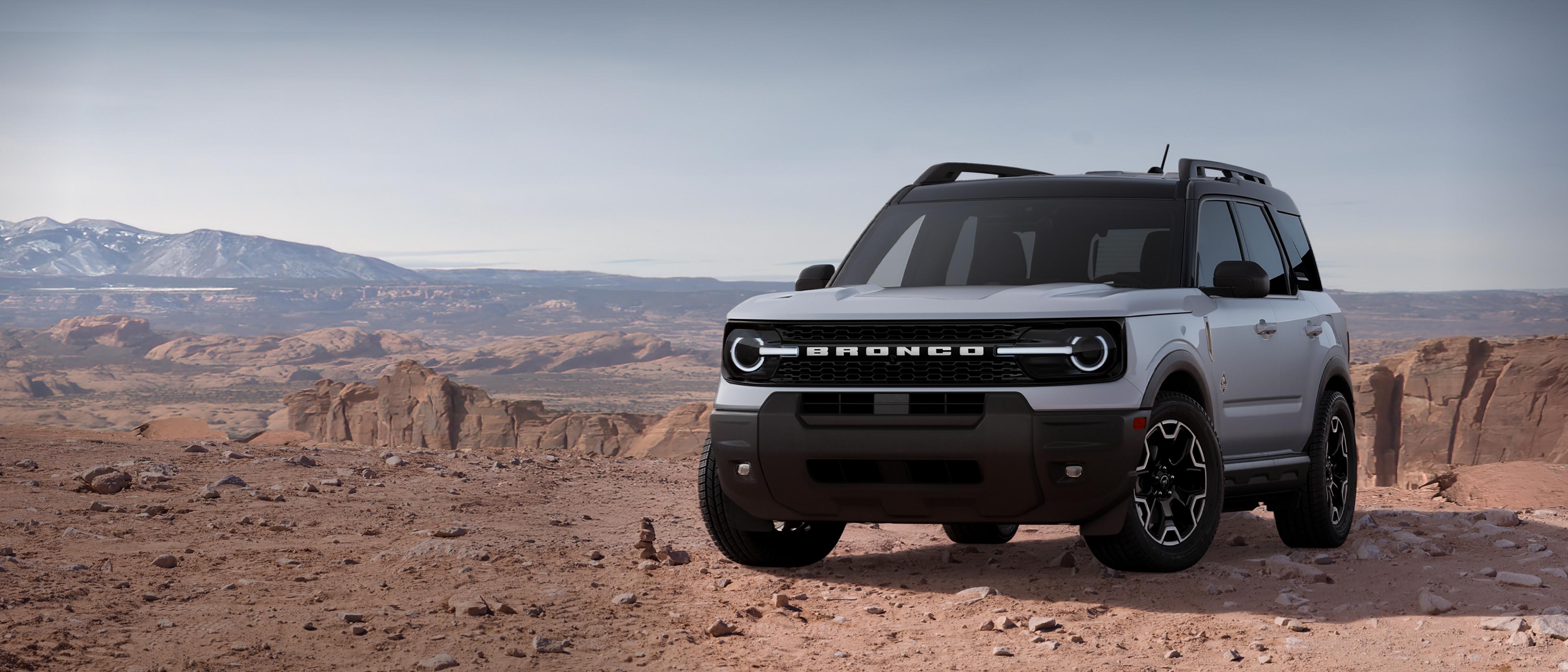 2026 Ford Bronco Sport® Outer Banks® model parked on dirt with rocky cliffs in background