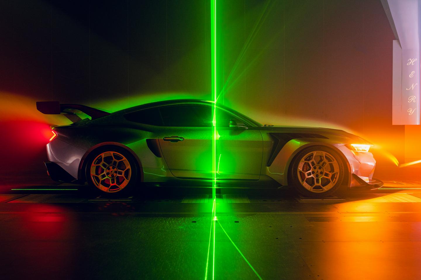 A parked Mustang GTD, awash in neon colours